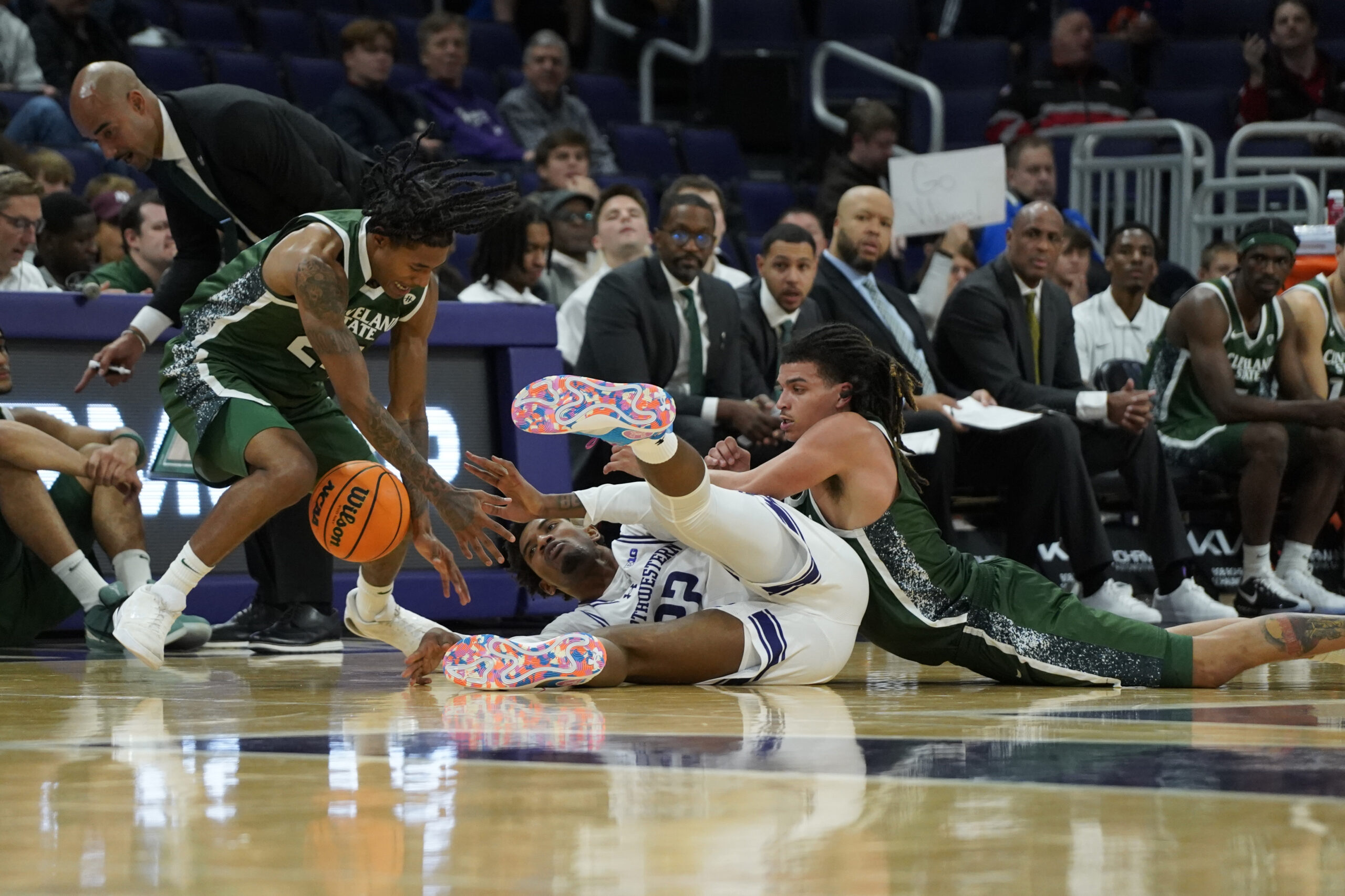 Nov 10, 2025; Evanston, Illinois, USA; Cleveland State Vikings guard Kamari Jones (24) forward Preist Ryan (4) and Northwestern Wildcats forward Arrinten Page (22) go for a loose ball during the second half at Welsh-Ryan Arena. Mandatory Credit: David Banks-Imagn Images