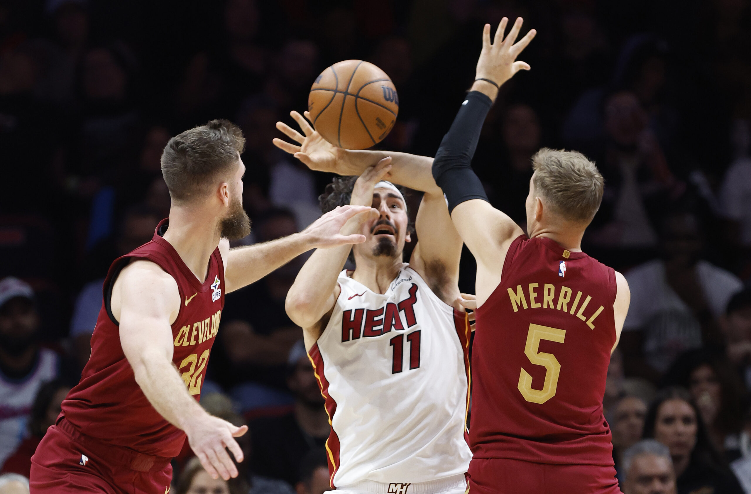 Nov 10, 2025; Miami, Florida, USA; Cleveland Cavaliers forward Dean Wade (32) and guard Sam Merrill (5) defend Miami Heat forward Jaime Jaquez Jr. (11) during the second half at Kaseya Center. Mandatory Credit: Rhona Wise-Imagn Images