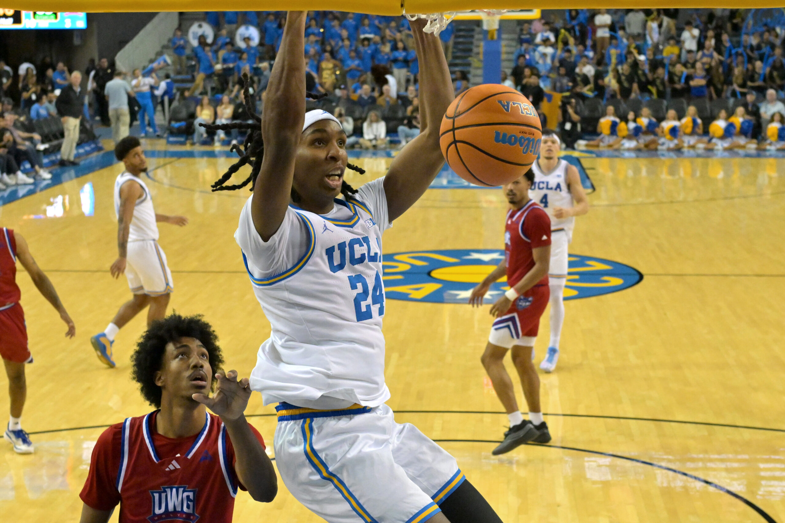 Nov 10, 2025; Los Angeles, California, USA; UCLA Bruins center Steven Jamerson II (24) drives past West Georgia Wolves forward Javar Daniel (5) for a dunk during the second half at Pauley Pavilion presented by Wescom Financial. Mandatory Credit: Jayne Kamin-Oncea-Imagn Images