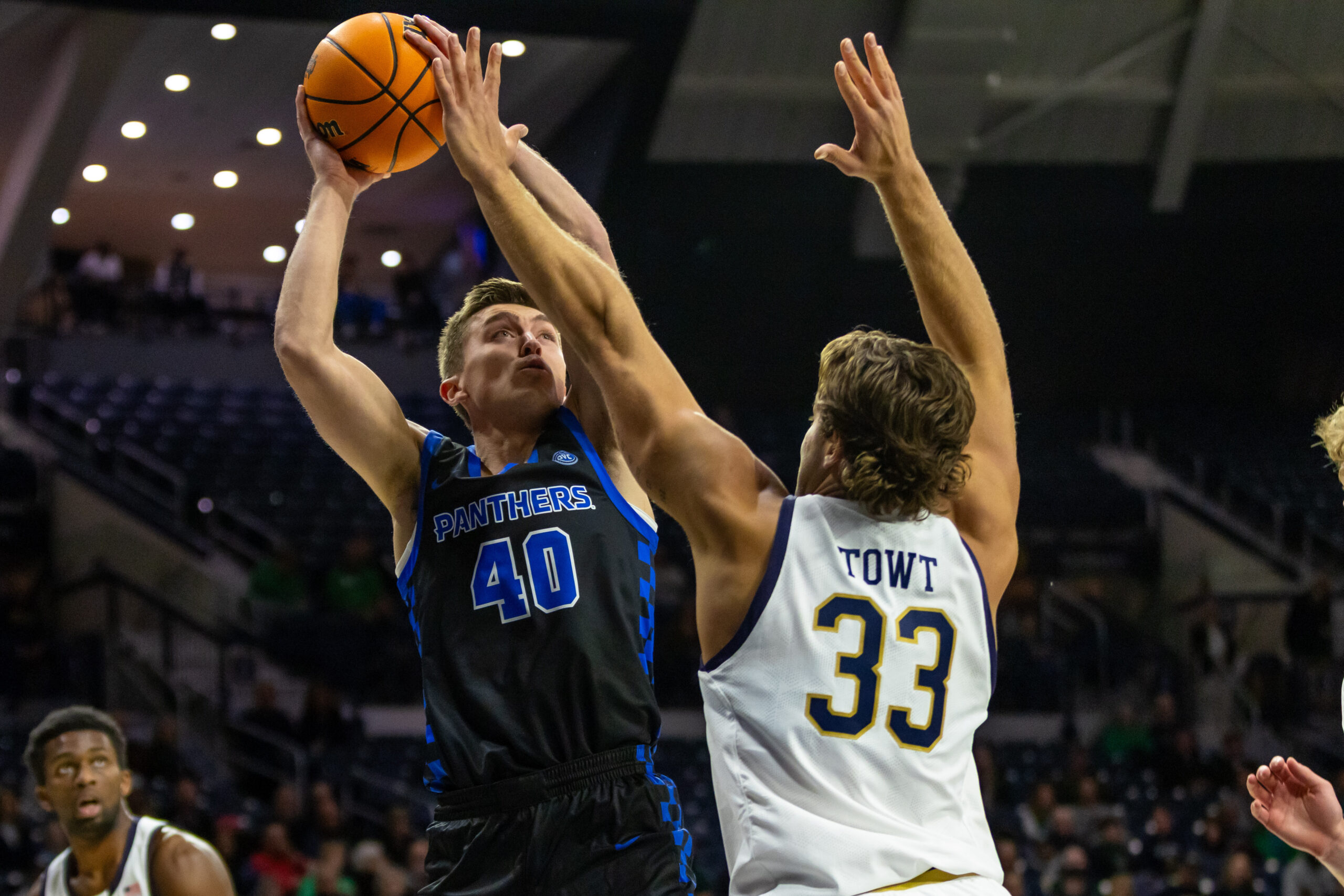 Nov 11, 2025; South Bend, Indiana, USA; Eastern Illinois Panthers forward Kooper Jacobi (40) shoots as Notre Dame Fighting Irish forward Carson Towt (33) defends during the first half at Purcell Pavilion at the Joyce Center. Mandatory Credit: Michael Caterina-Imagn Images
