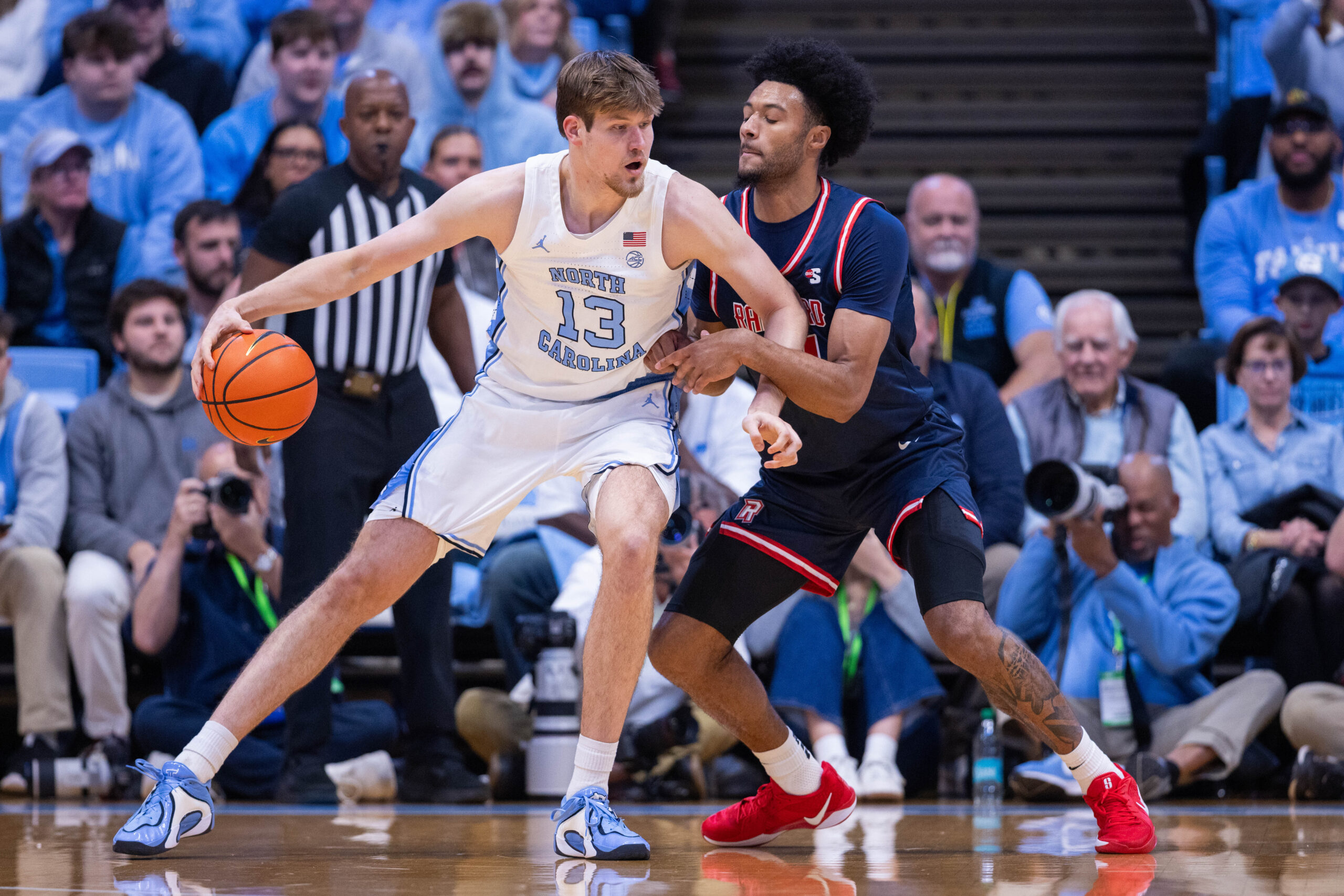 Nov 11, 2025; Chapel Hill, North Carolina, USA; North Carolina Tar Heels center Henri Veesaar (13) backs down on Radford Highlanders forward Tyson Brown (21) during the first half at Dean E. Smith Center. Mandatory Credit: Scott Kinser-Imagn Images