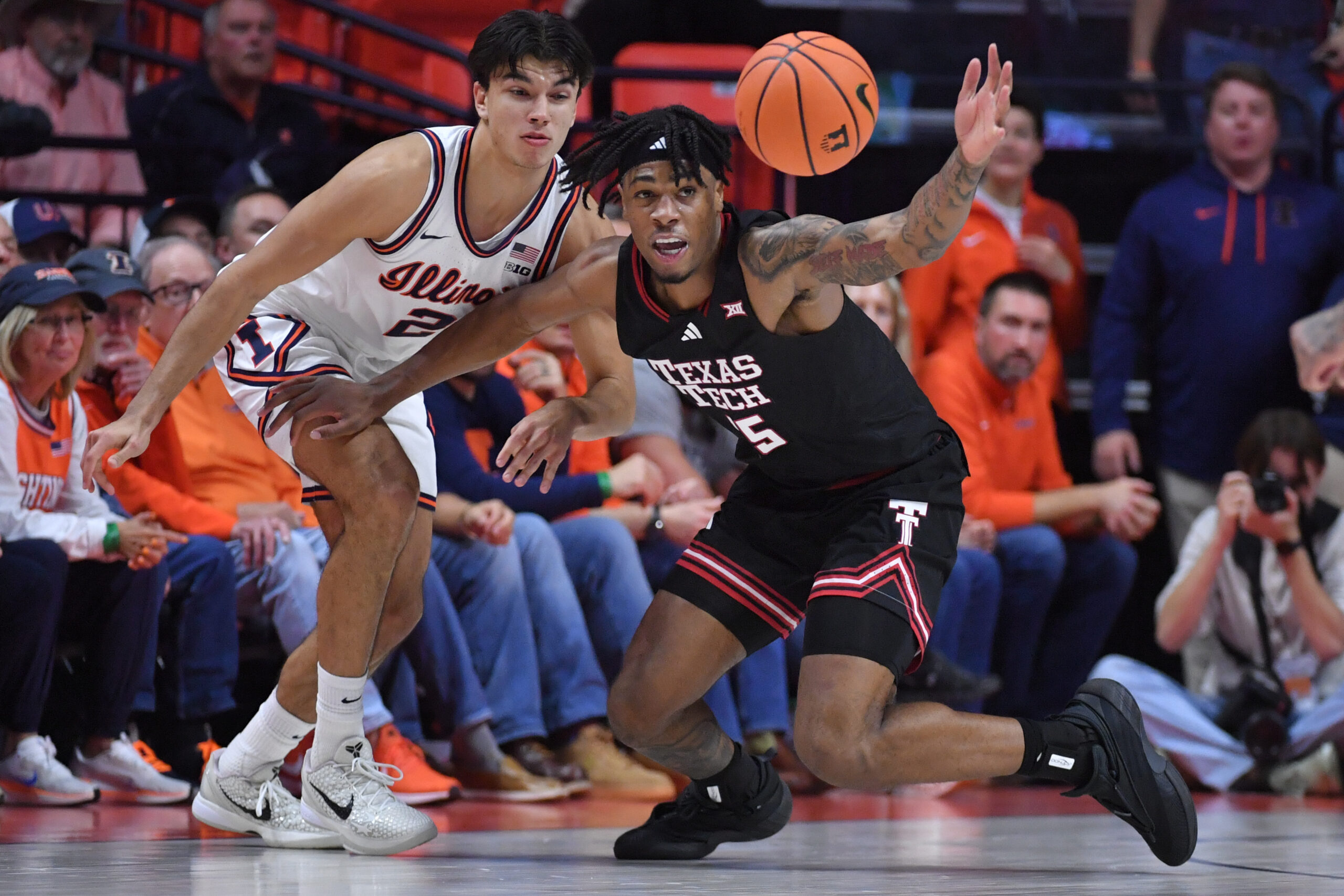 Nov 11, 2025; Champaign, Illinois, USA; Texas Tech Red Raiders forward JT Toppin (15) reaches for a loose ball in front of Illinois Fighting Illini guard Andrej Stojakovic (2) during the second half at State Farm Center. Mandatory Credit: Ron Johnson-Imagn Images