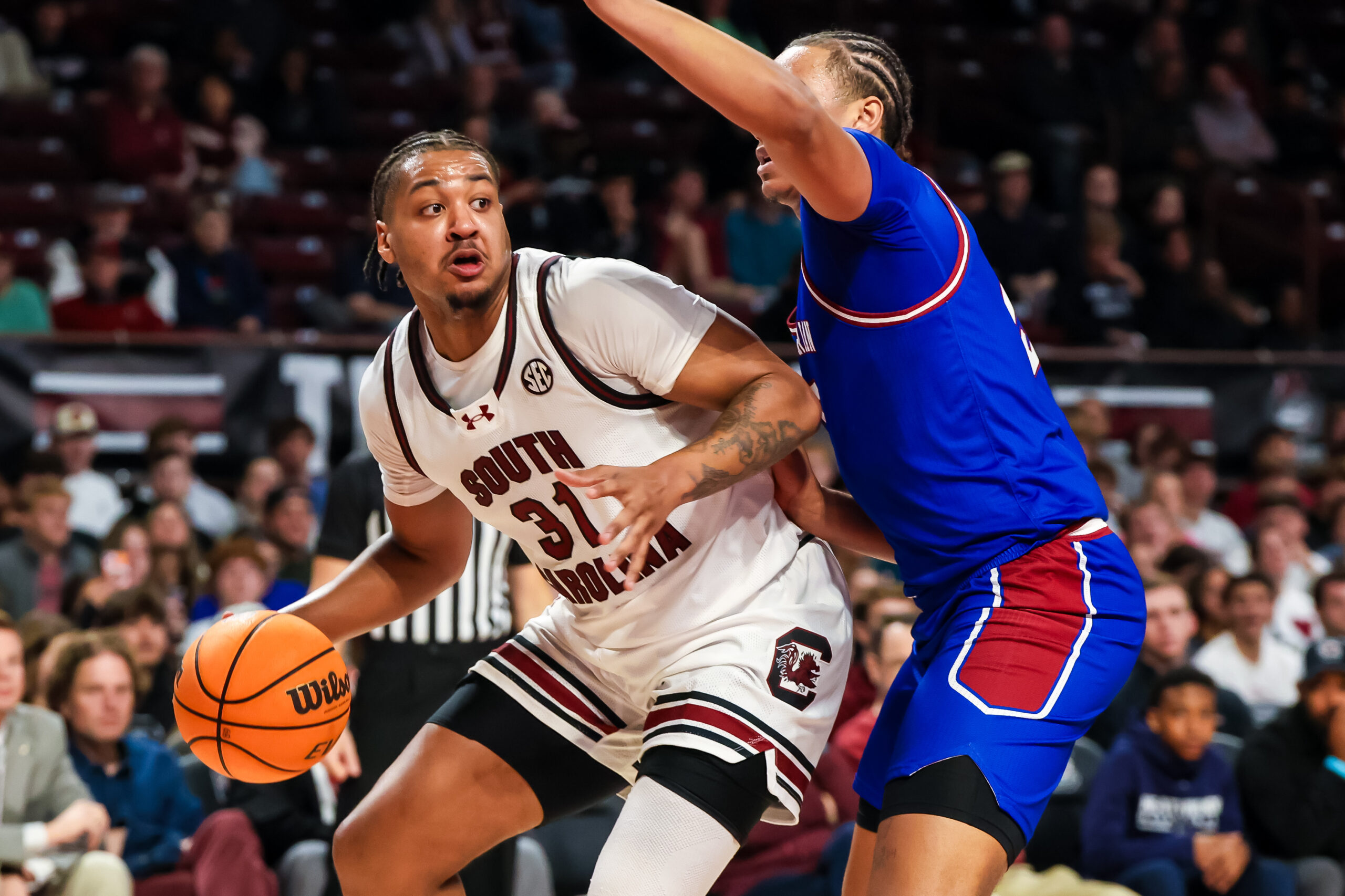 Nov 12, 2025; Columbia, South Carolina, USA; South Carolina Gamecocks forward Elijah Strong (31) attempts to get around Presbyterian Blue Hose forward Jonah Pierce (15) in the first half at Colonial Life Arena. Mandatory Credit: Jeff Blake-Imagn Images
