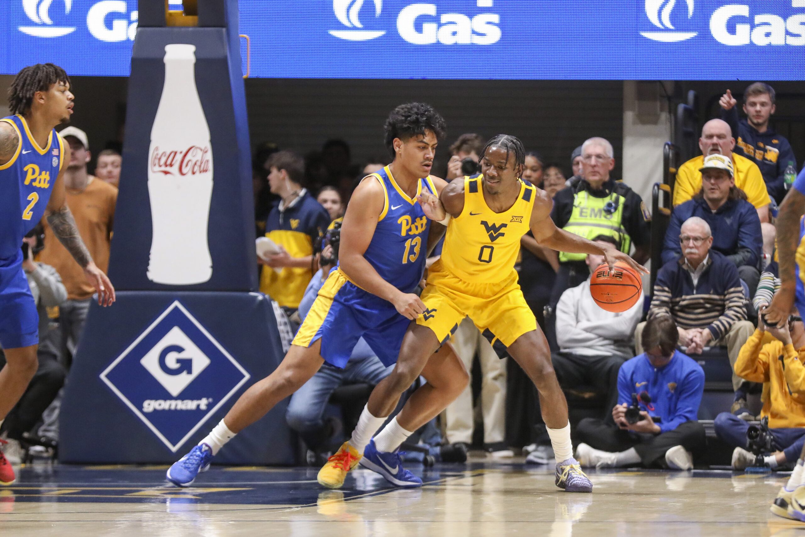Nov 13, 2025; Morgantown, West Virginia, USA; West Virginia Mountaineers forward Brenen Lorient (0) dribbles against Pittsburgh Panthers forward Roman Siulepa (13) during the first half at WVU Coliseum. Mandatory Credit: Ben Queen-Imagn Images
