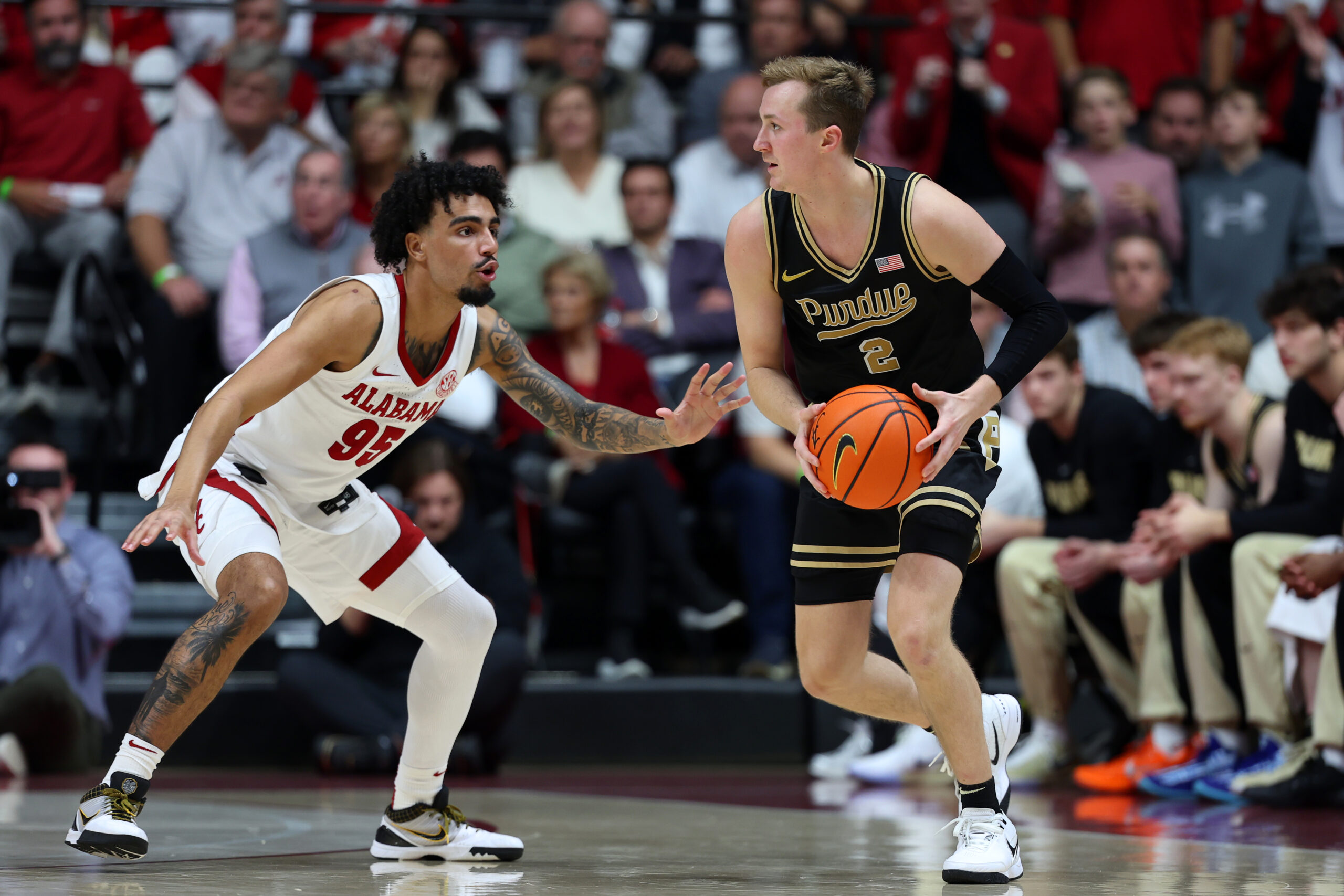 Nov 13, 2025; Tuscaloosa, Alabama, USA; Alabama Crimson Tide guard Houston Mallette (95) guards Purdue Boilermakers guard Fletcher Loyer (2) during the second half at Coleman Coliseum. Mandatory Credit: David Leong-Imagn Images