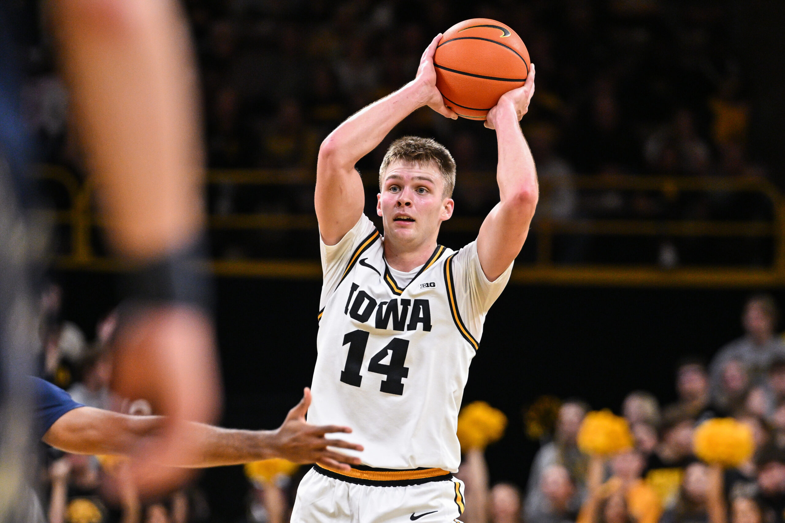 Nov 14, 2025; Iowa City, Iowa, USA; Iowa Hawkeyes guard Bennett Stirtz (14) looks to pass the ball during the second half against the Xavier Musketeers at Carver-Hawkeye Arena. Mandatory Credit: Jeffrey Becker-Imagn Images