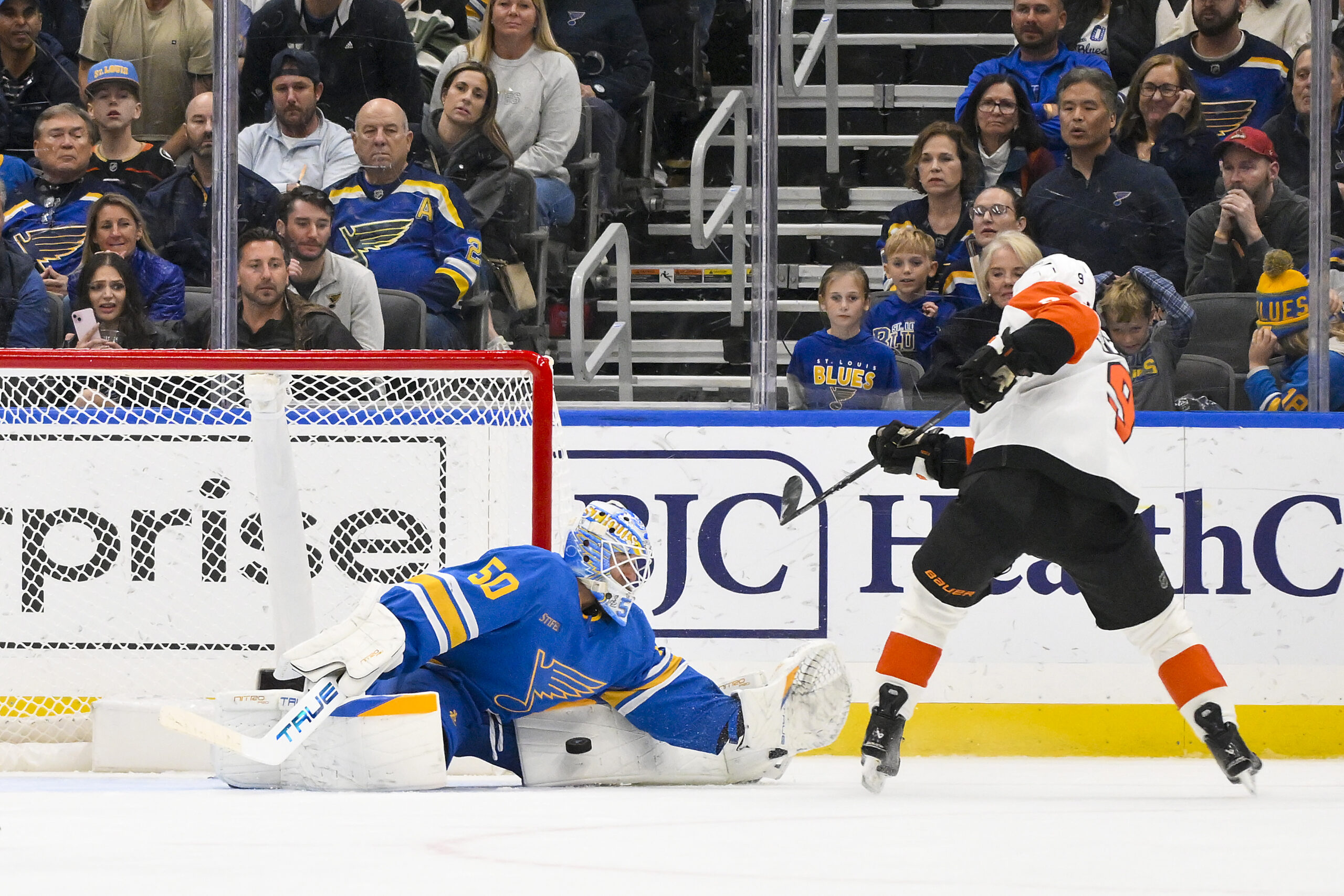 Nov 14, 2025; St. Louis, Missouri, USA; St. Louis Blues goaltender Jordan Binnington (50) makes a save against Philadelphia Flyers defenseman Jamie Drysdale (9) during overtime at Enterprise Center. Mandatory Credit: Jeff Curry-Imagn Images