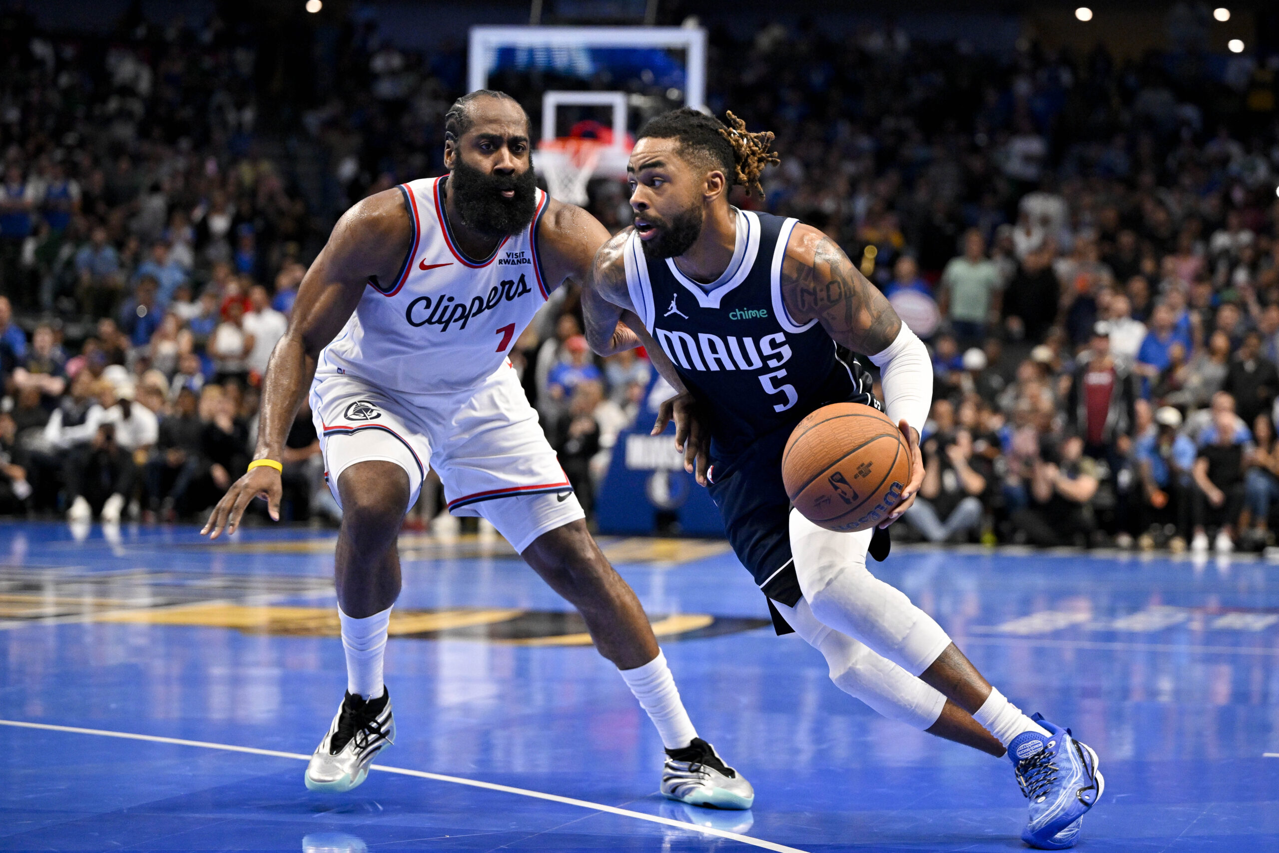 Nov 14, 2025; Dallas, Texas, USA; Dallas Mavericks guard D'Angelo Russell (5) drives to the basket past LA Clippers guard James Harden (1) during the second half in an NBA Cup game at the American Airlines Center. Mandatory Credit: Jerome Miron-Imagn Images