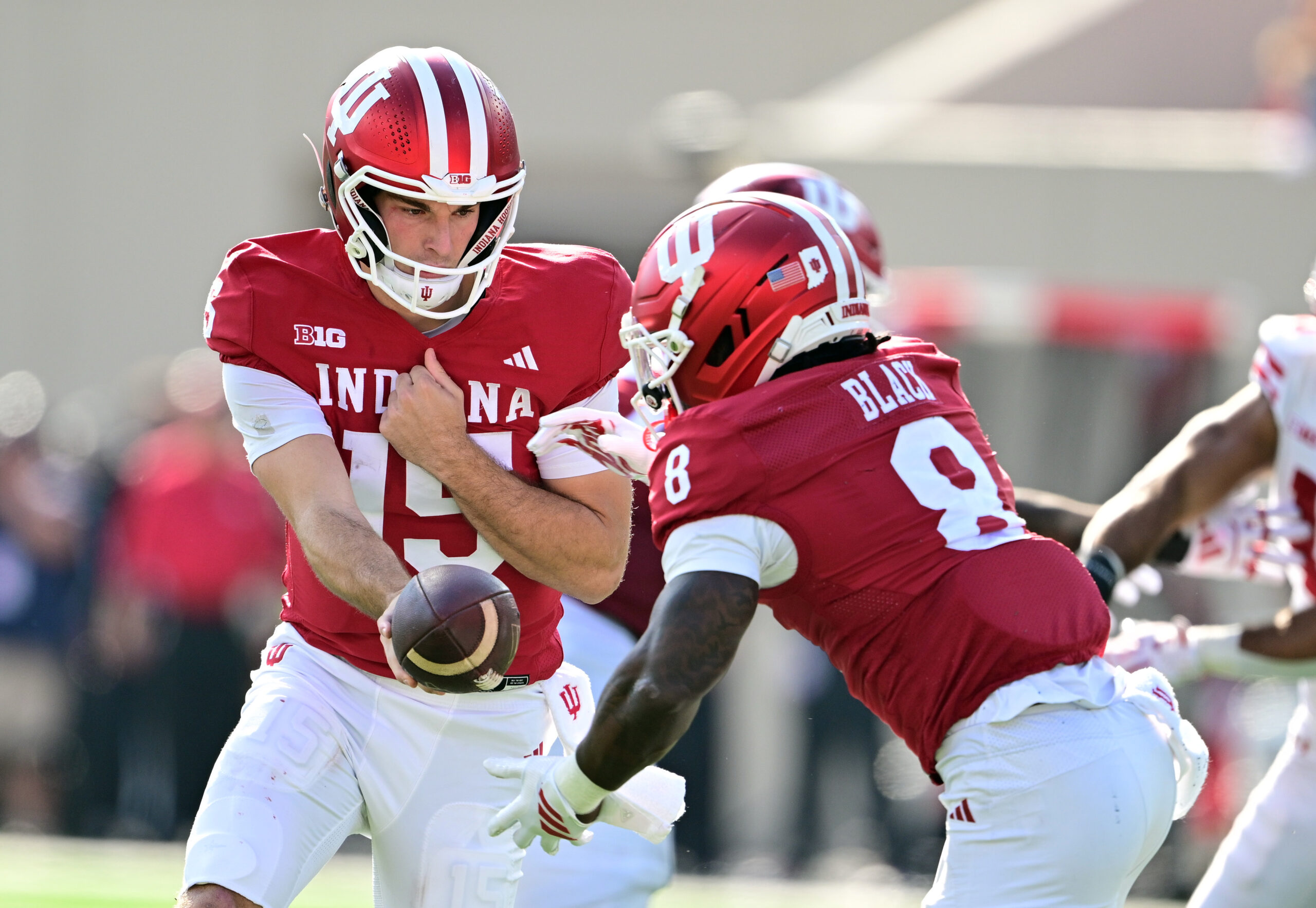 Nov 15, 2025; Bloomington, Indiana, USA;  Indiana Hoosiers quarterback Fernando Mendoza (15) hands the ball off to Indiana Hoosiers running back Kaelon Black (8) during the second half against the Wisconsin Badgers at Memorial Stadium. Mandatory Credit: Marc Lebryk-Imagn Images