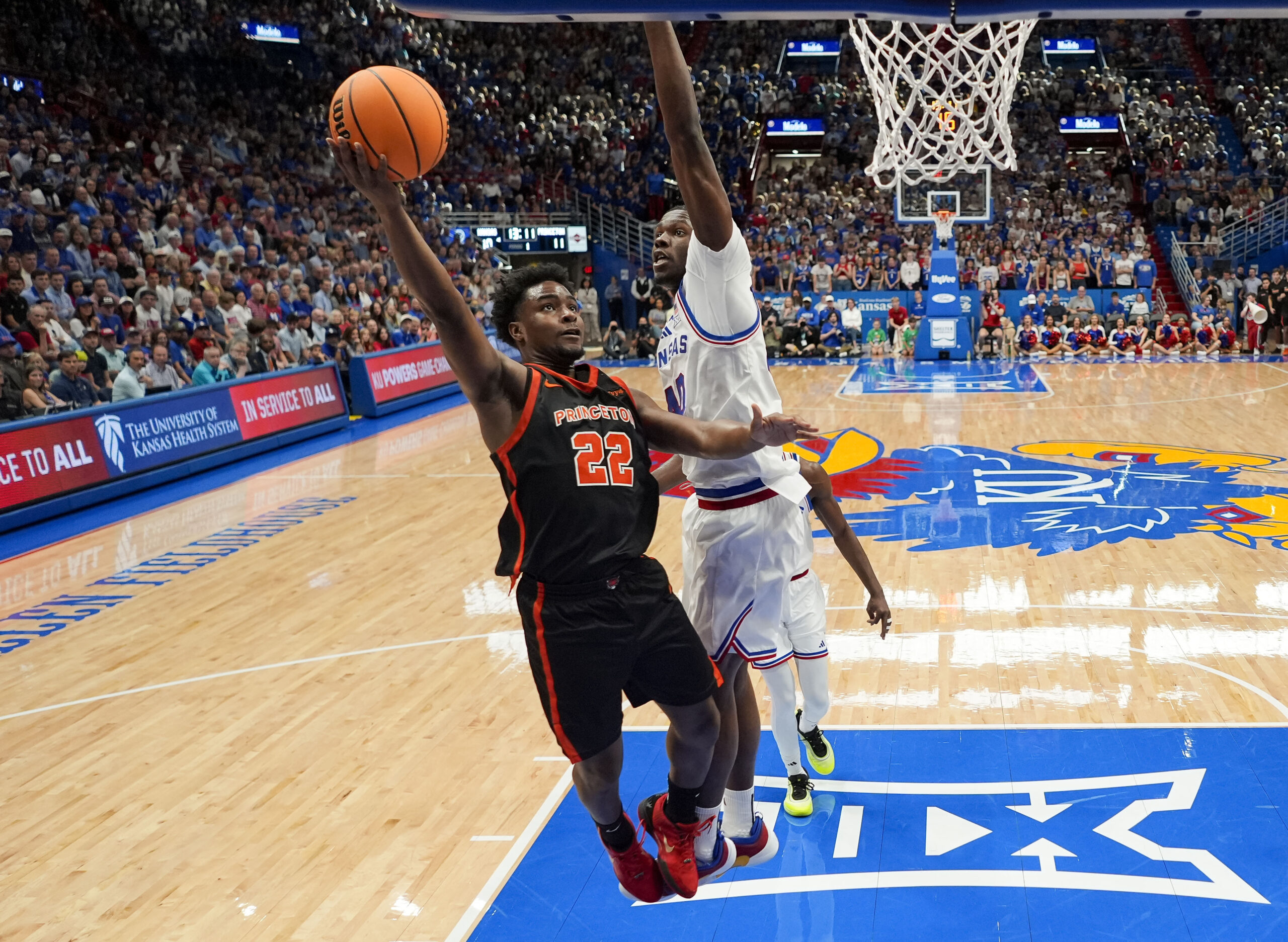 Nov 15, 2025; Lawrence, Kansas, USA; Princeton Tigers guard Dalen Davis (22) shoots against Kansas Jayhawks forward Flory Bidunga (40) during the first half at Allen Fieldhouse. Mandatory Credit: Jay Biggerstaff-Imagn Images