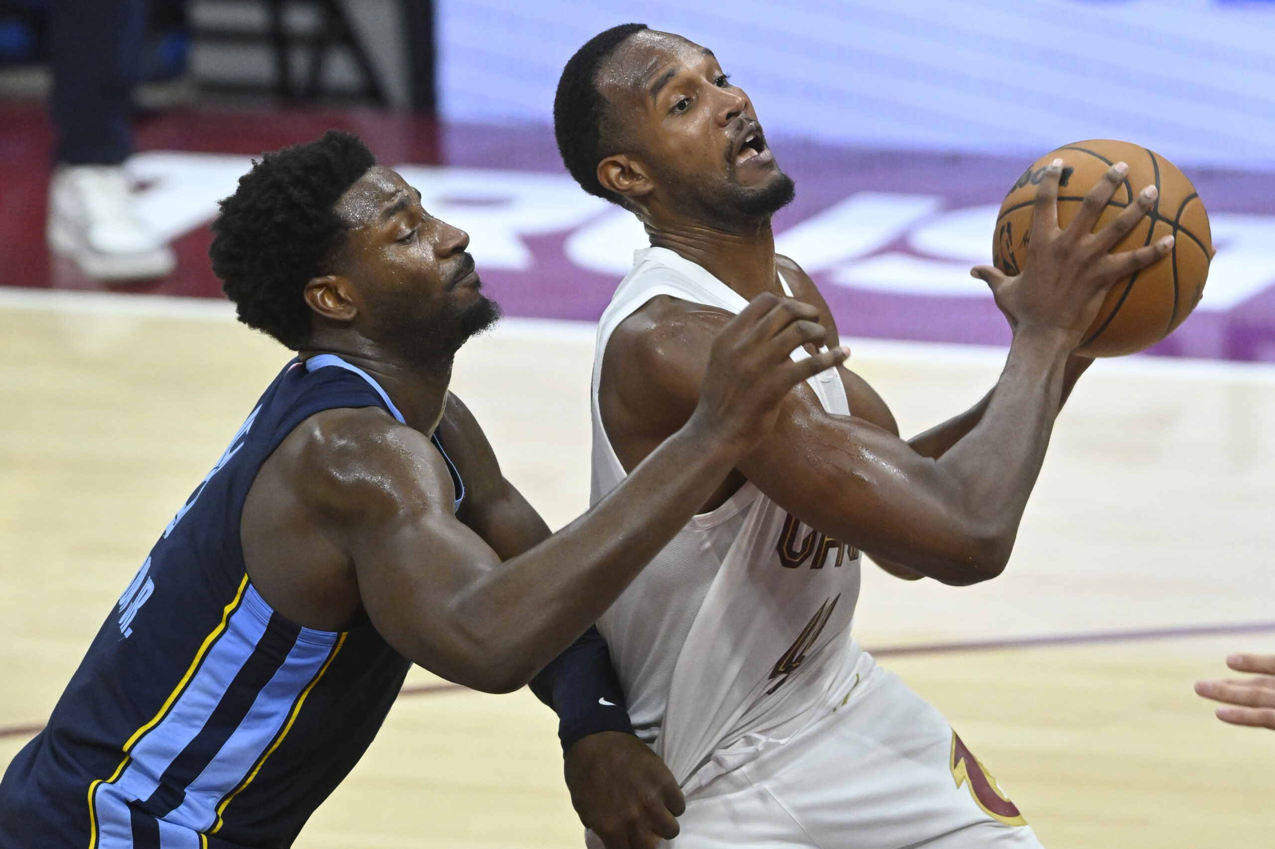 Nov 15, 2025; Cleveland, Ohio, USA; Cleveland Cavaliers center Evan Mobley (4) drives to the basket beside Memphis Grizzlies forward Jaren Jackson Jr. (8) in the fourth quarter at Rocket Arena. Mandatory Credit: David Richard-Imagn Images