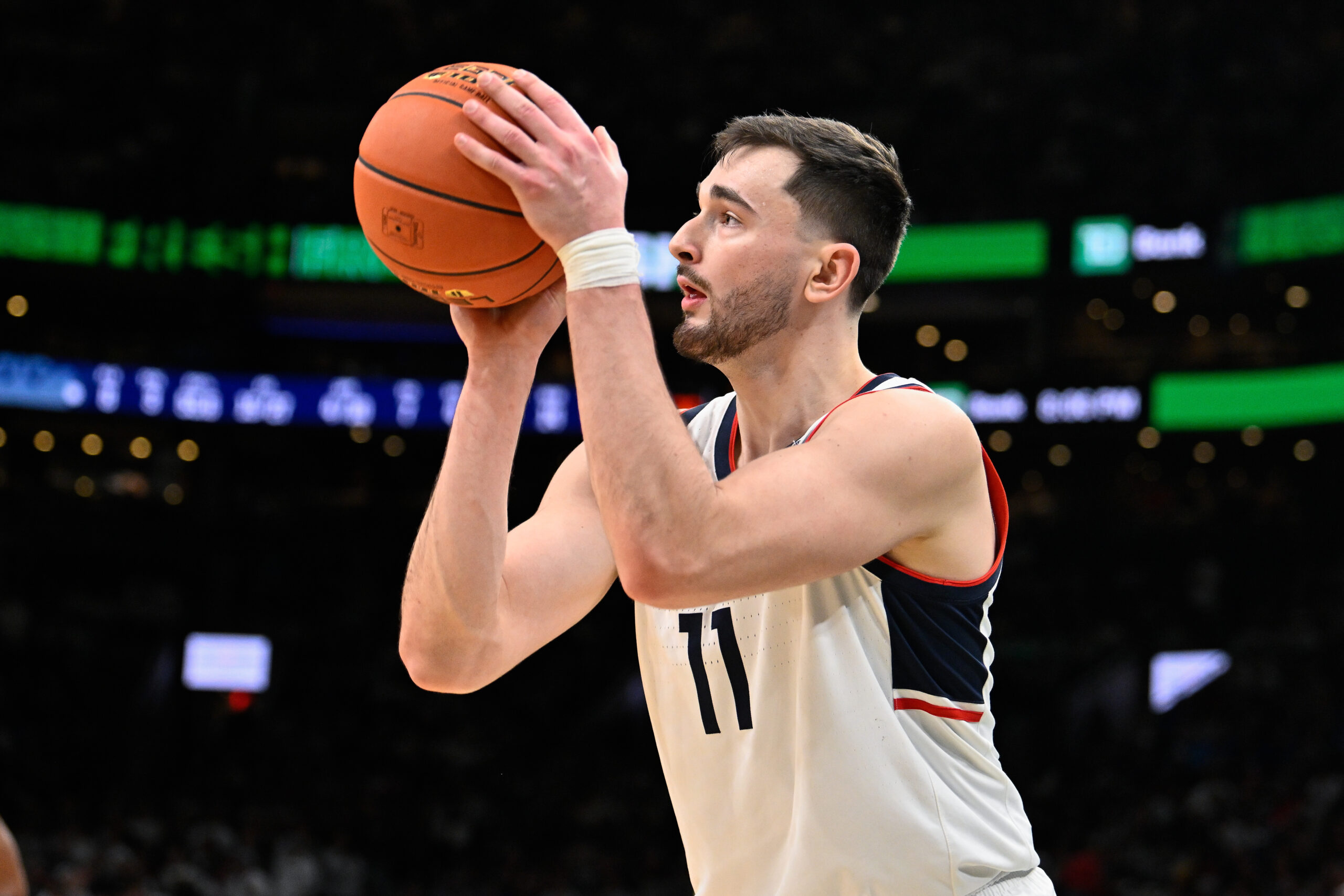Nov 15, 2025; Boston, Massachusetts, USA; UConn Huskies forward Alex Karaban (11) makes a three point basket against the BYU Cougars during the first half at TD Garden. Mandatory Credit: Eric Canha-Imagn Images