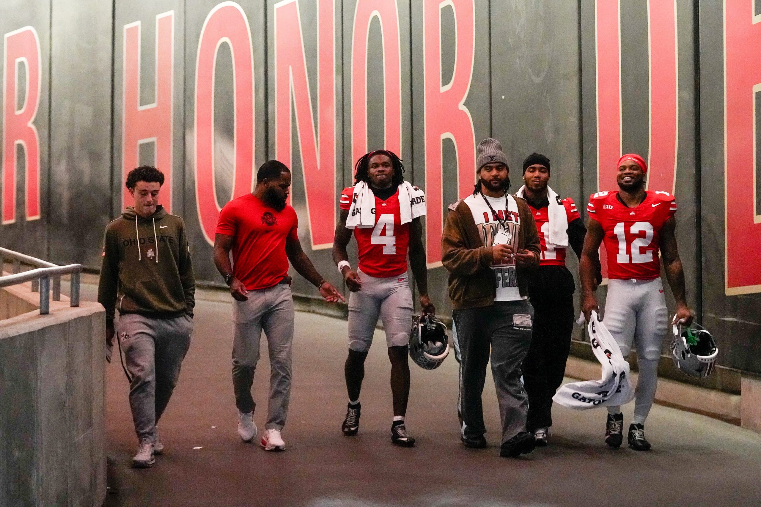 From left to right, R.J. Day, CJ Barnett, wide receiver Jeremiah Smith (4), J.T. Tuimoloau, linebacker C.J. Hicks (11) and running back CJ Donaldson Jr. (12) walk down the tunnel at halftime of the NCAA college football game at Ohio Stadium on Saturday, Nov. 15, 2025 in Columbus, Ohio.