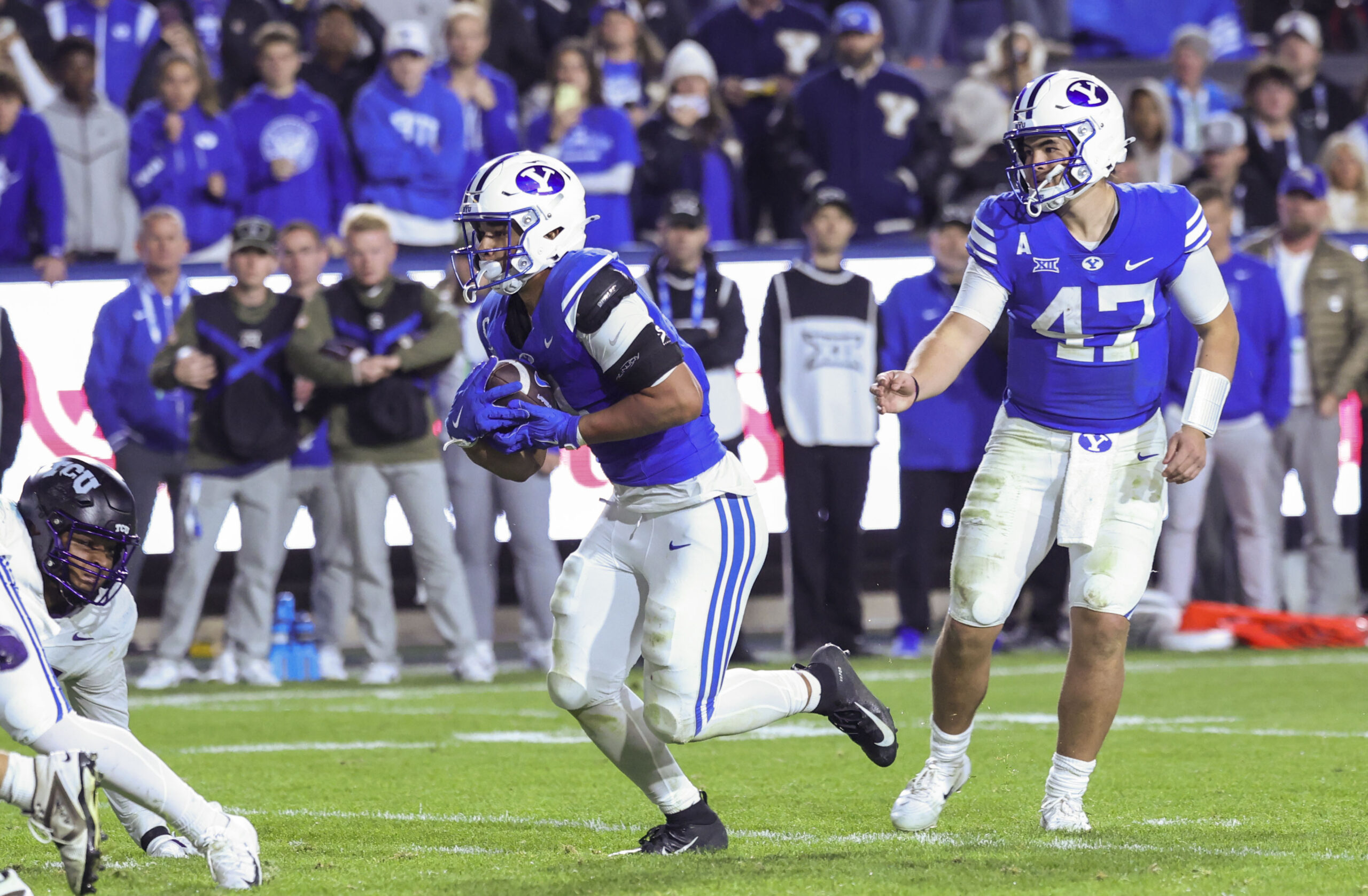 Nov 15, 2025; Provo, Utah, USA; BYU Cougars quarterback Bear Bachmeier (47) hands the ball off to running back LJ Martin (4) to score a touchdown against the Texas Christian University Horned Frogs during the fourth quarter at LaVell Edwards Stadium. Mandatory Credit: Rob Gray-Imagn Images