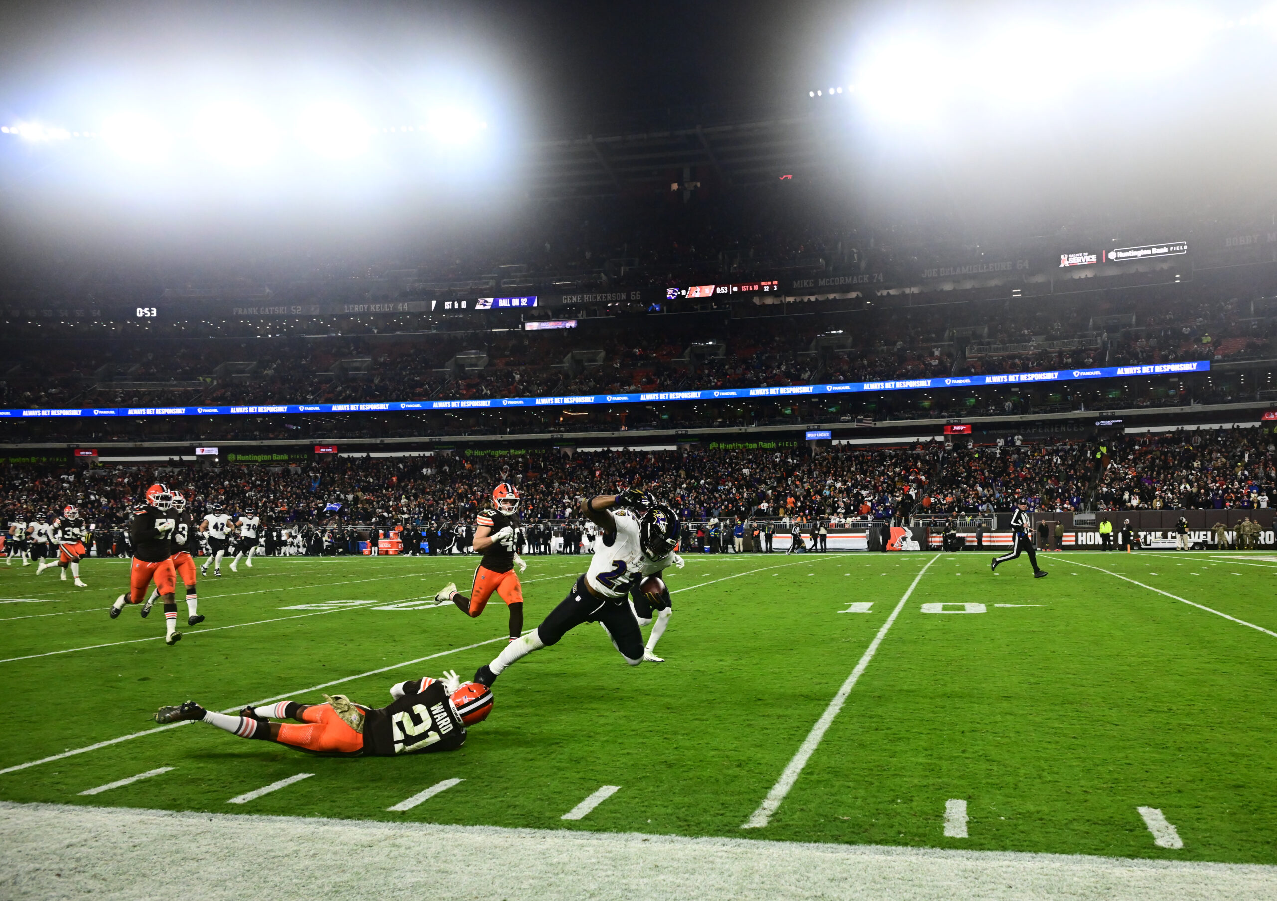Nov 16, 2025; Cleveland, Ohio, USA; Baltimore Ravens running back Derrick Henry (22) is tackled by Cleveland Browns cornerback Denzel Ward (21) during the third quarter at Huntington Bank Field. Mandatory Credit: Ken Blaze-Imagn Images