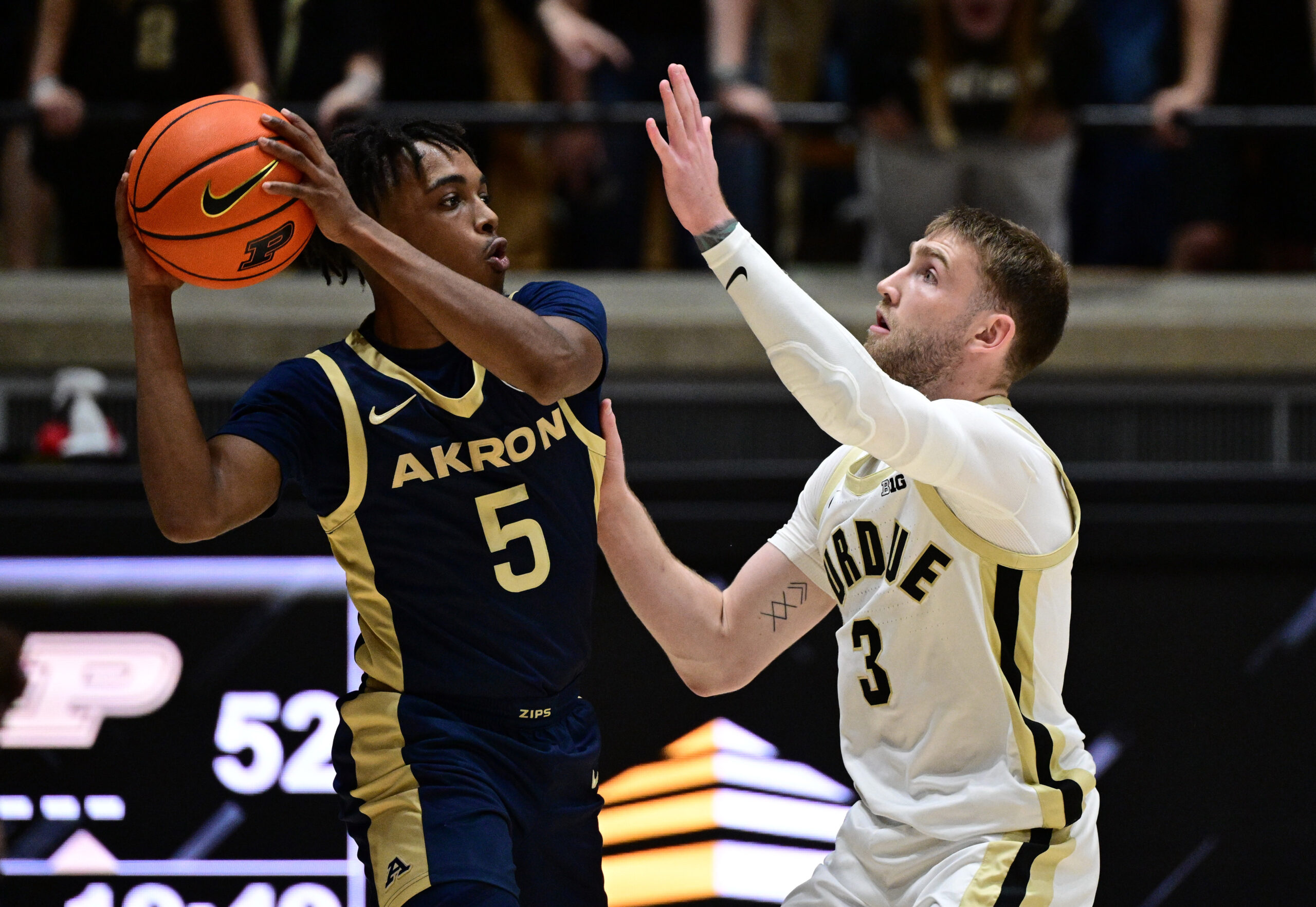 Nov 16, 2025; West Lafayette, Indiana, USA; Akron Zips guard Tavari Johnson (5) looks to get past Purdue Boilermakers guard Braden Smith (3) during the second half at Mackey Arena. Mandatory Credit: Marc Lebryk-Imagn Images