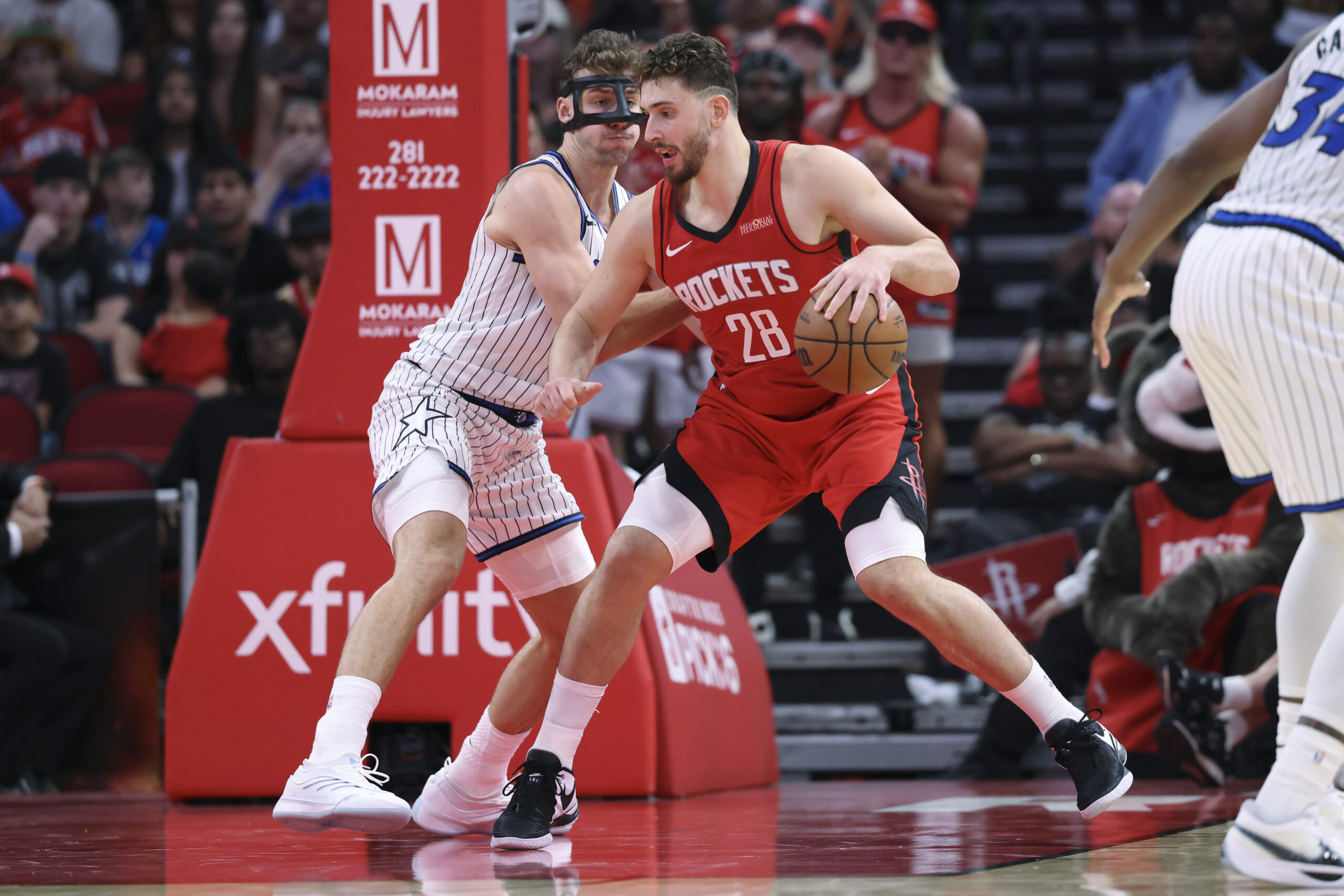 Nov 16, 2025; Houston, Texas, USA; Houston Rockets center Alperen Sengun (28) controls the ball as Orlando Magic forward Franz Wagner (22) defends during the fourth quarter at Toyota Center. Mandatory Credit: Troy Taormina-Imagn Images