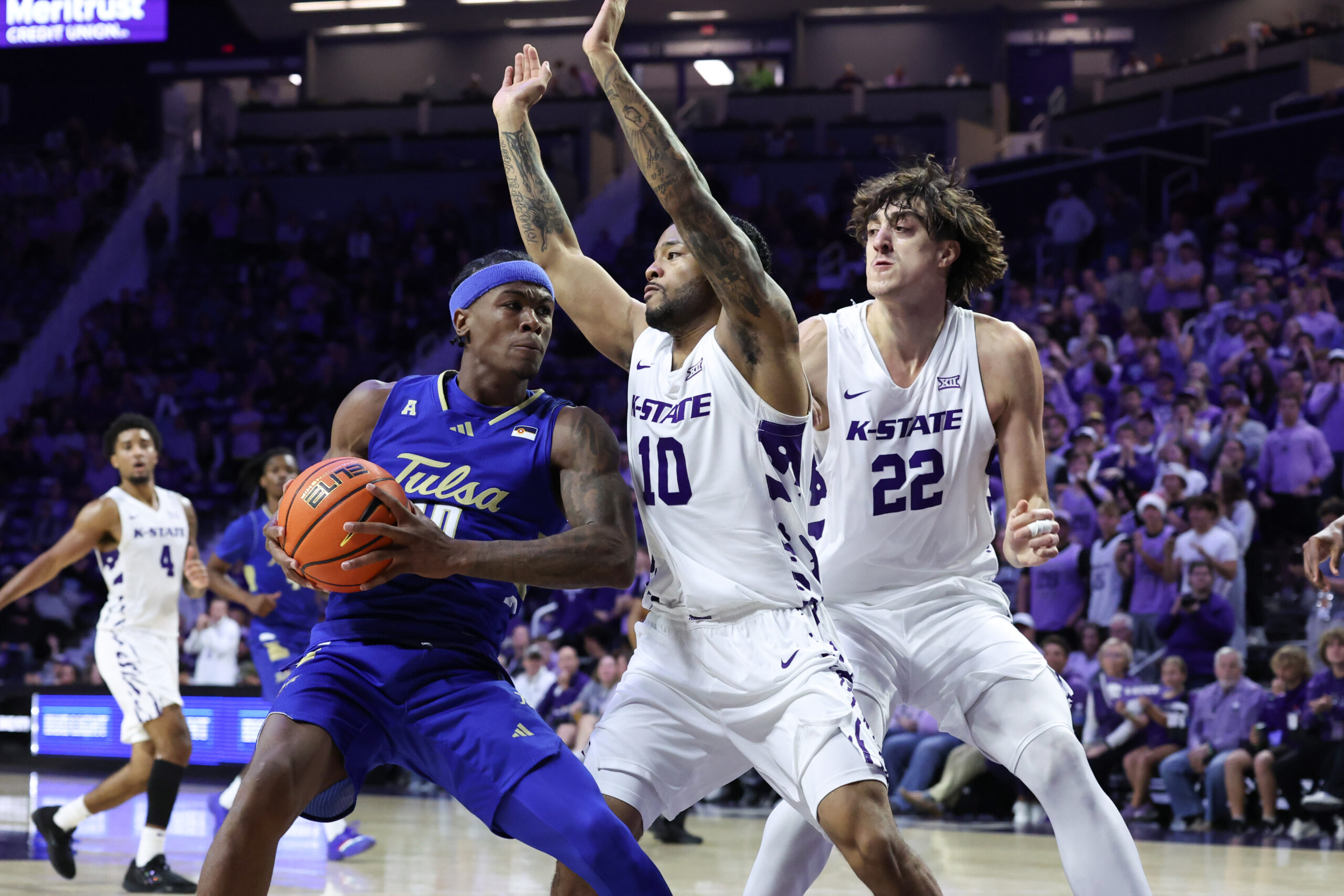 Nov 17, 2025; Manhattan, Kansas, USA; Tulsa Golden Hurricane guard Tylen Riley (10) looks for room to move against Kansas State Wildcats guard David Castillo (10) and center Dorin Buca (22) during the second half at Bramlage Coliseum. Mandatory Credit: Scott Sewell-Imagn Images