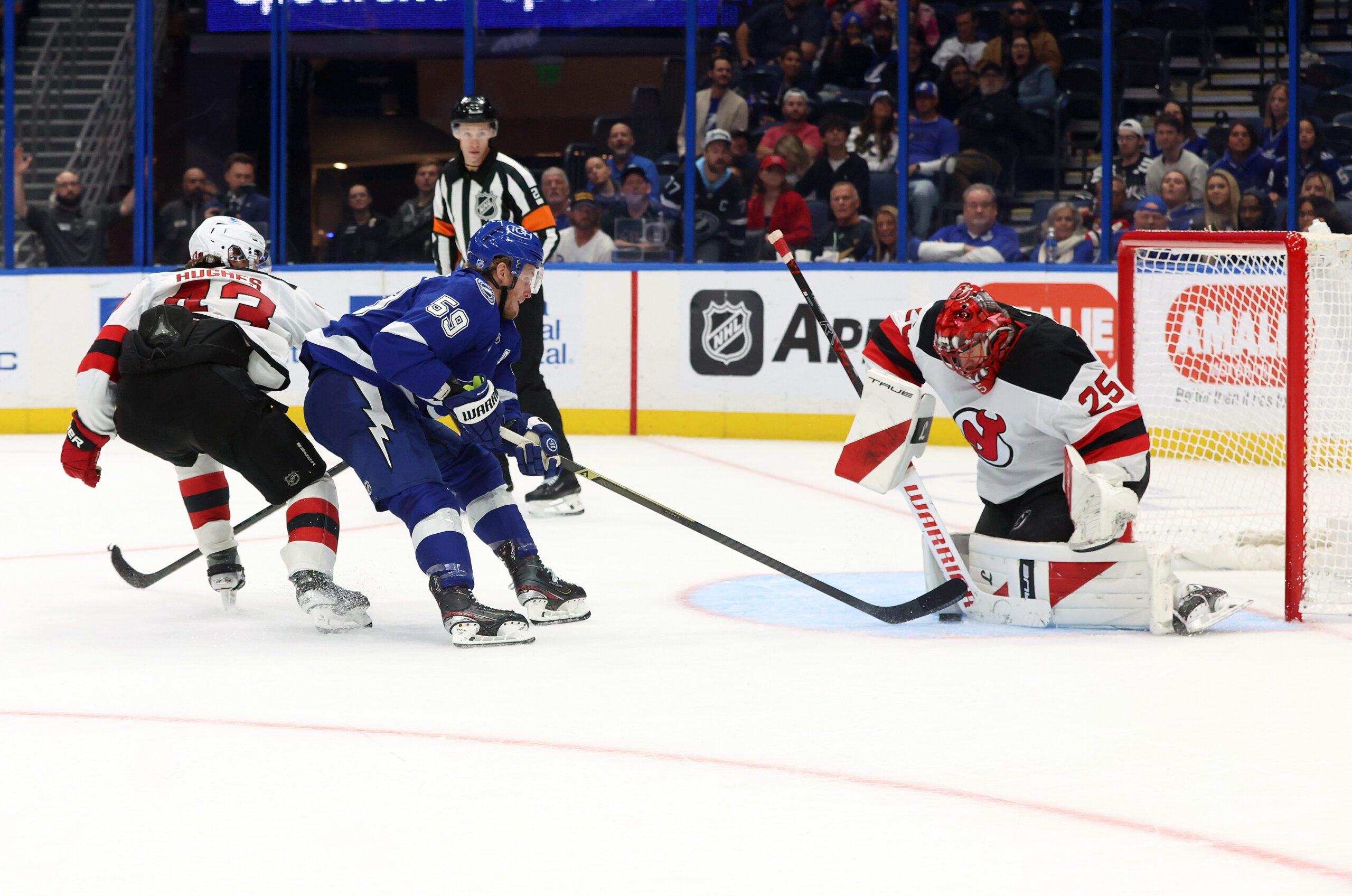 Nov 18, 2025; Tampa, Florida, USA; Tampa Bay Lightning center Jake Guentzel (59) shoots as New Jersey Devils goaltender Jacob Markstrom (25) makes a save during the third period at Benchmark International Arena. Mandatory Credit: Kim Klement Neitzel-Imagn Images