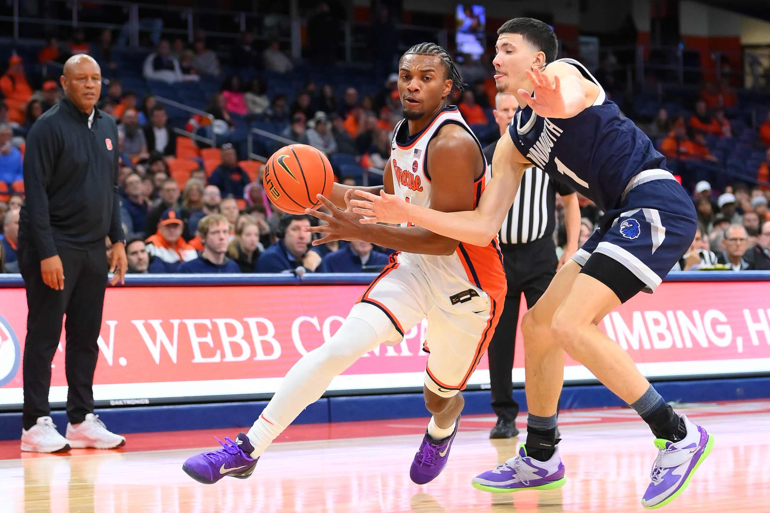 Nov 18, 2025; Syracuse, New York, USA; Syracuse Orange guard J.J. Starling (2) drives against Monmouth Hawks forward Jason Rivera-Torres (1) during the second half at the JMA Wireless Dome. Mandatory Credit: Rich Barnes-Imagn Images