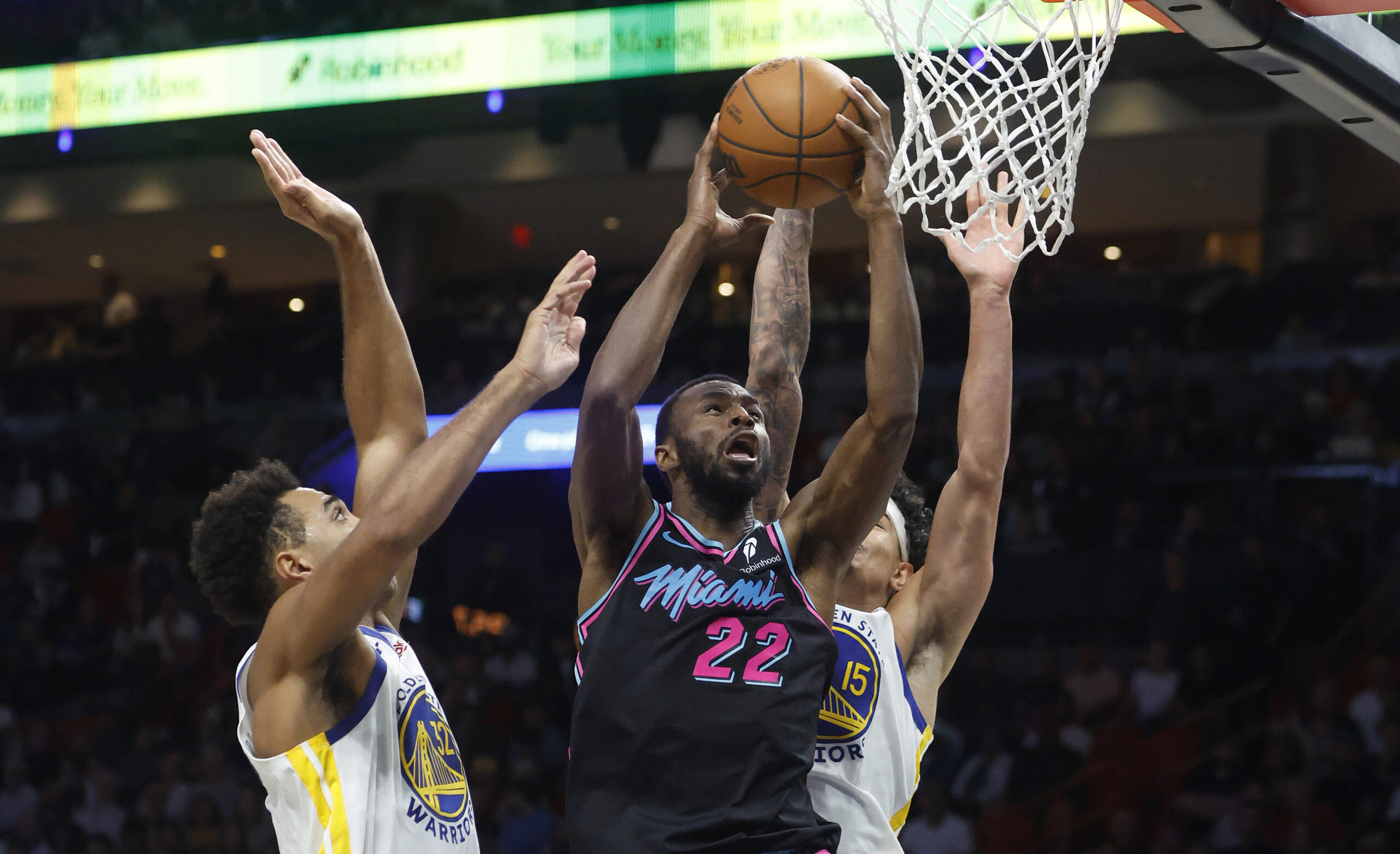 Nov 19, 2025; Miami, Florida, USA;  Miami Heat forward Andrew Wiggins (22) shoots between Golden State Warriors forward Trayce Jackson-Davis (32) and forward Gui Santos (15) during the second half at Kaseya Center. Mandatory Credit: Rhona Wise-Imagn Images
