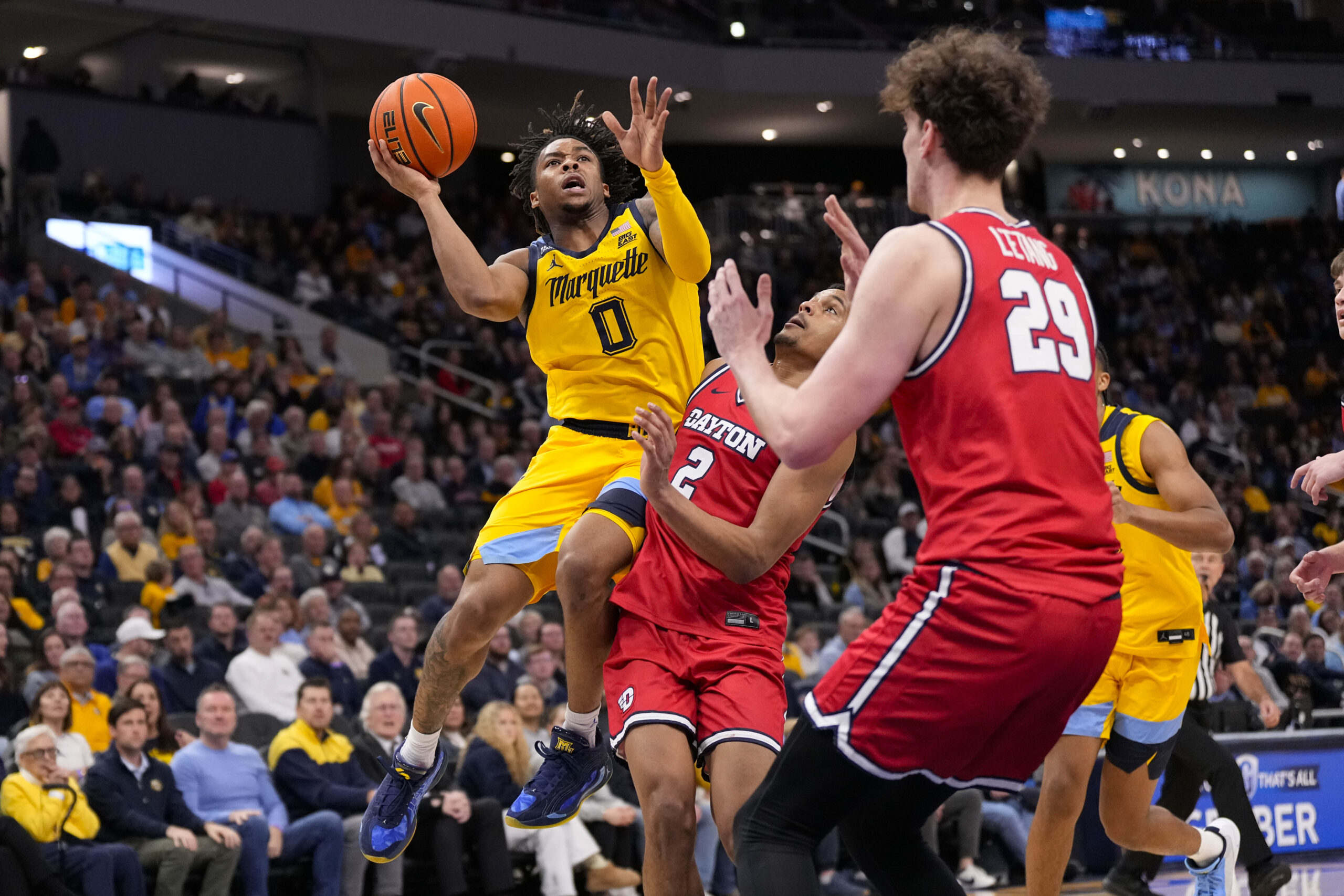 Nov 19, 2025; Milwaukee, Wisconsin, USA;  Marquette Golden Eagles guard Nigel James Jr. (0) shoots over Dayton Flyers guard De'Shayne Montgomery (2) during the second half at Fiserv Forum. Mandatory Credit: Jeff Hanisch-Imagn Images