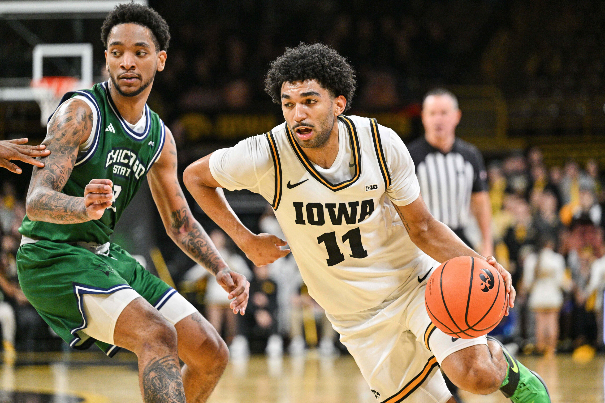 Nov 20, 2025; Iowa City, Iowa, USA; Iowa Hawkeyes guard Kael Combs (11) goes to the basket as Chicago State Cougars forward Stephen Byard (8) defends during the second half at Carver-Hawkeye Arena. Mandatory Credit: Jeffrey Becker-Imagn Images