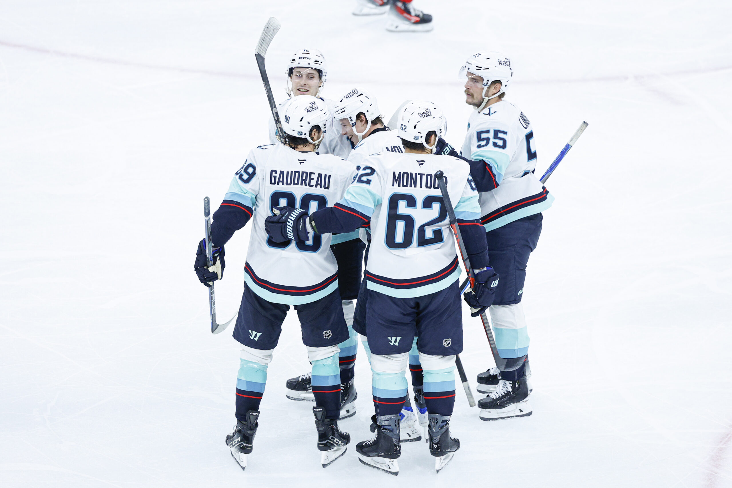 Nov 20, 2025; Chicago, Illinois, USA; Seattle Kraken left wing Tye Kartye (12) celebrates with teammates after scoring against the Chicago Blackhawks during the third period at United Center. Mandatory Credit: Kamil Krzaczynski-Imagn Images