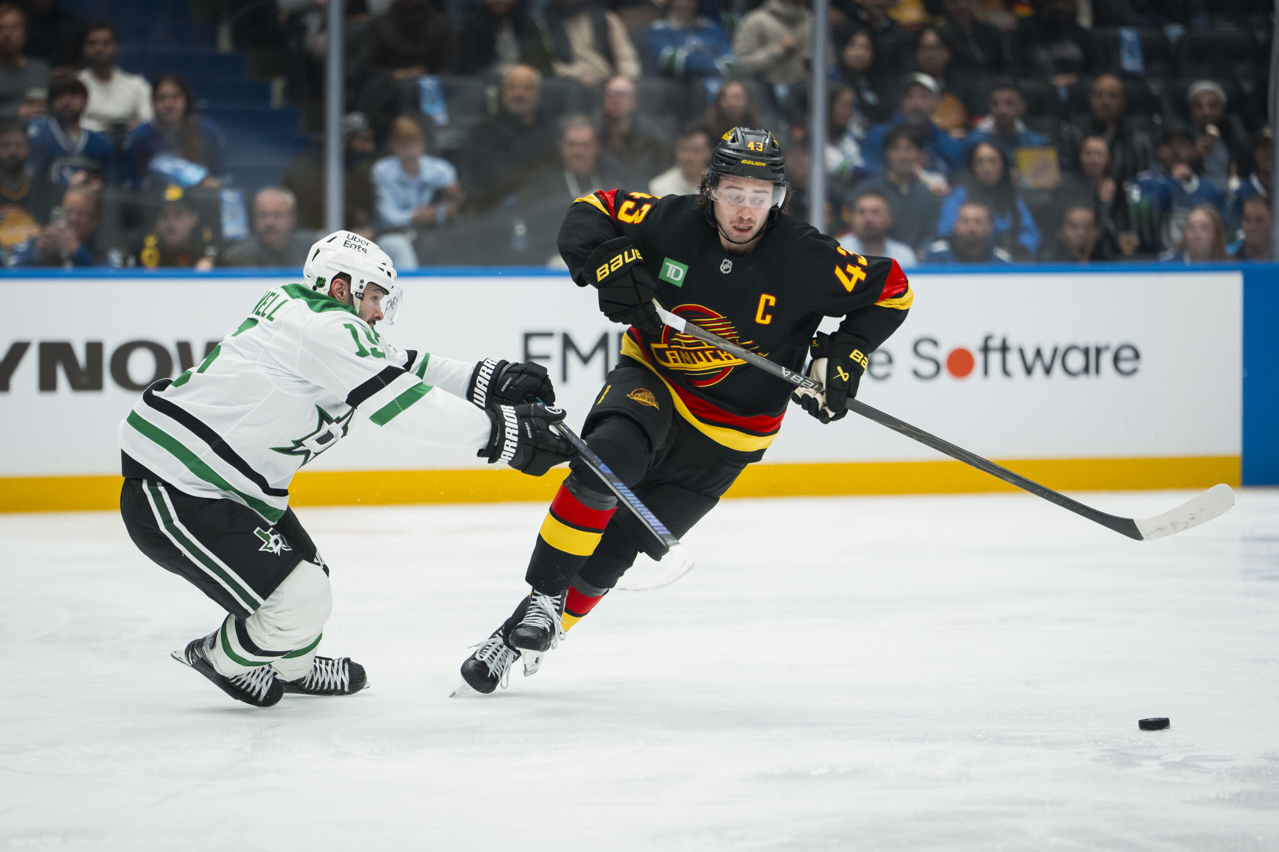 Nov 20, 2025; Vancouver, British Columbia, CAN; Vancouver Canucks defenseman Quinn Hughes (43) drives past Dallas Stars forward Colin Blackwell (15) in the second period at Rogers Arena. Mandatory Credit: Bob Frid-Imagn Images