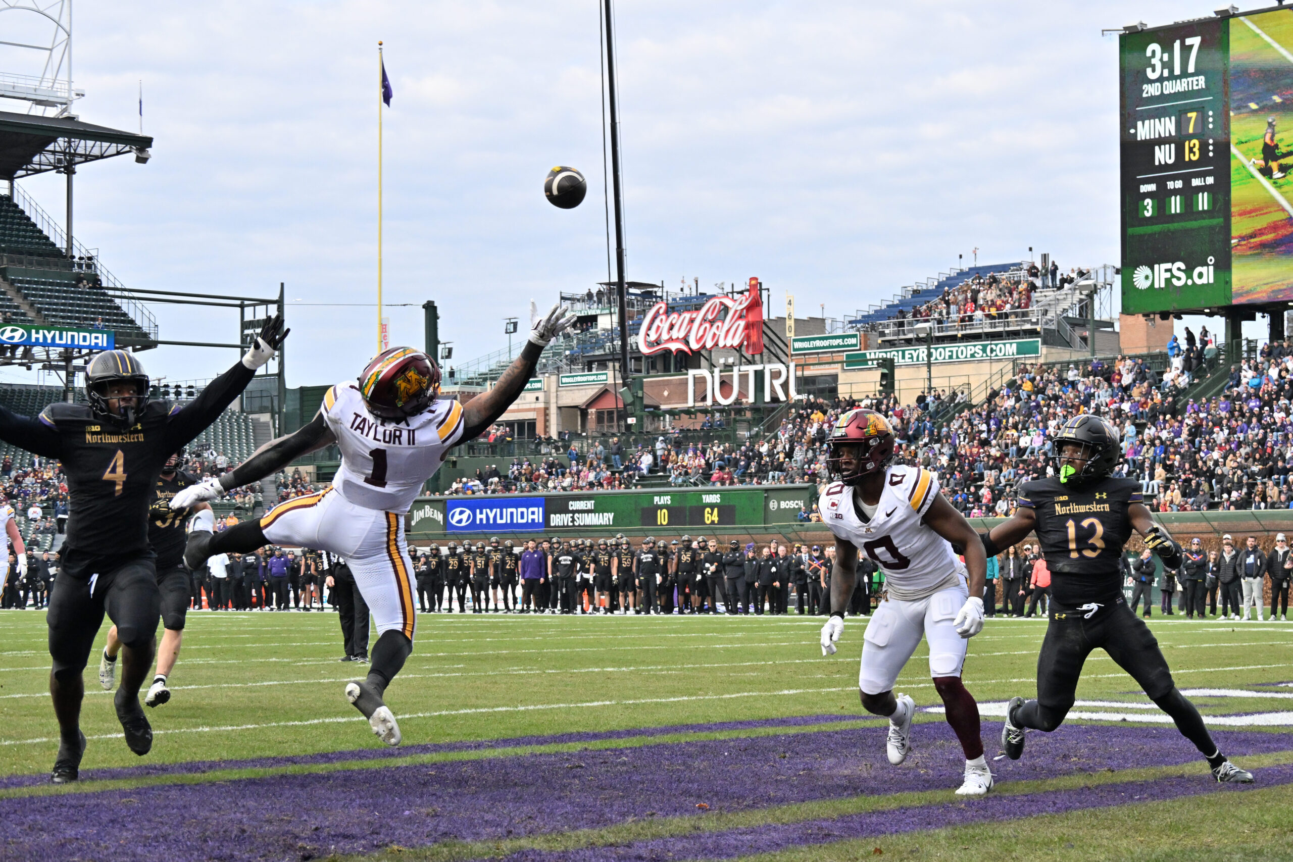 Nov 22, 2025; Chicago, Illinois, USA; Minnesota Golden Gophers running back Darius Taylor (1) is unable to pull in a pass next to Northwestern Wildcats defensive lineman Anto Saka (4) during the first half at Wrigley Field. Mandatory Credit: Patrick Gorski-Imagn Images