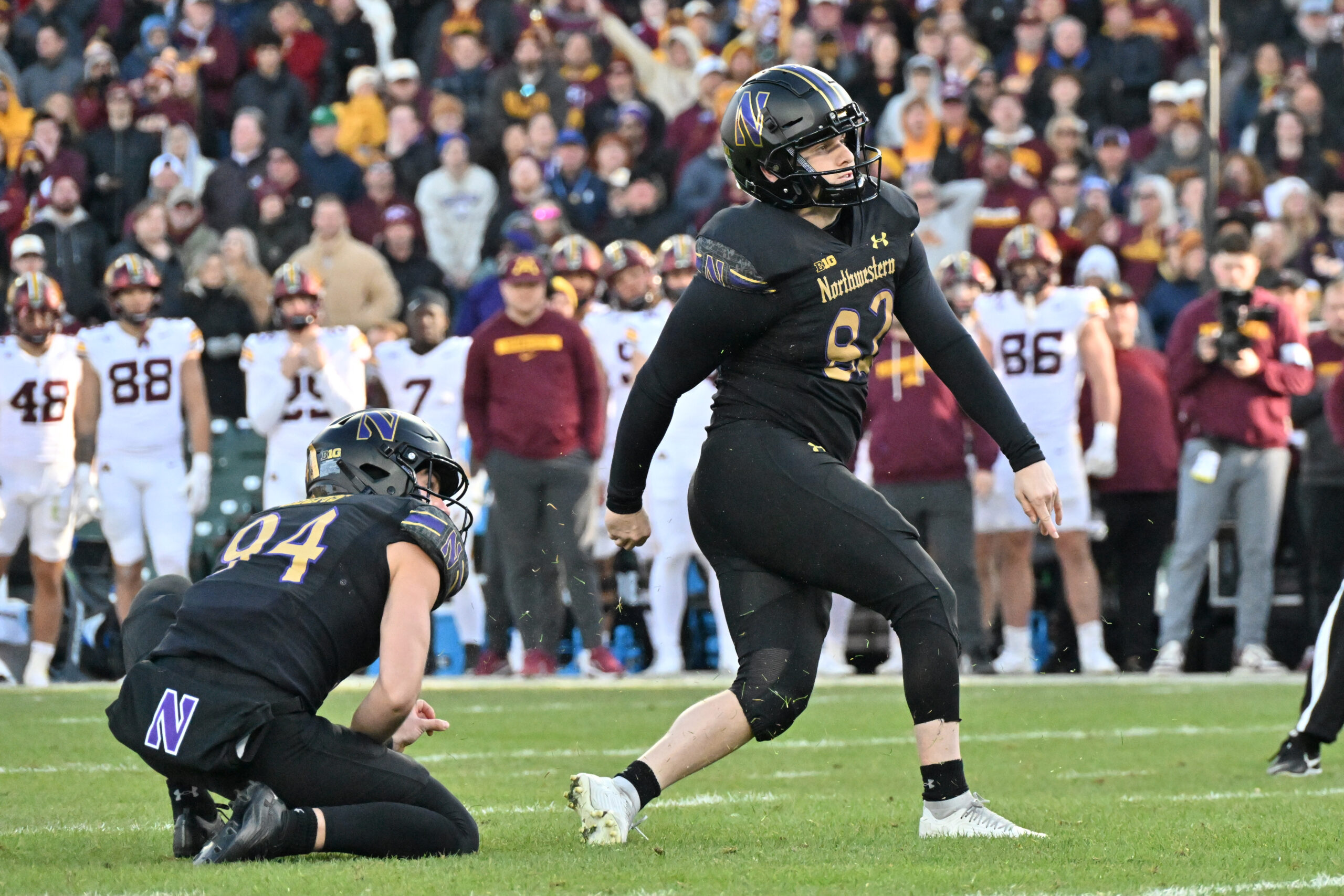 Nov 22, 2025; Chicago, Illinois, USA; Northwestern Wildcats kicker Jack Olsen (82) kicks the game winning field goal against the Minnesota Golden Gophers during the second half at Wrigley Field. Mandatory Credit: Patrick Gorski-Imagn Images