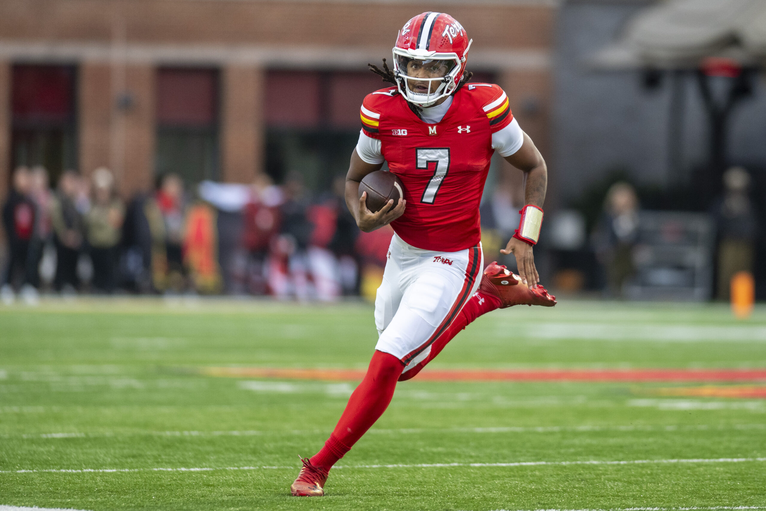 Nov 22, 2025; College Park, Maryland, USA; Maryland Terrapins quarterback Malik Washington (7) scrambles during the first quarter against the Michigan Wolverines at SECU Stadium. Mandatory Credit: Tommy Gilligan-Imagn Images