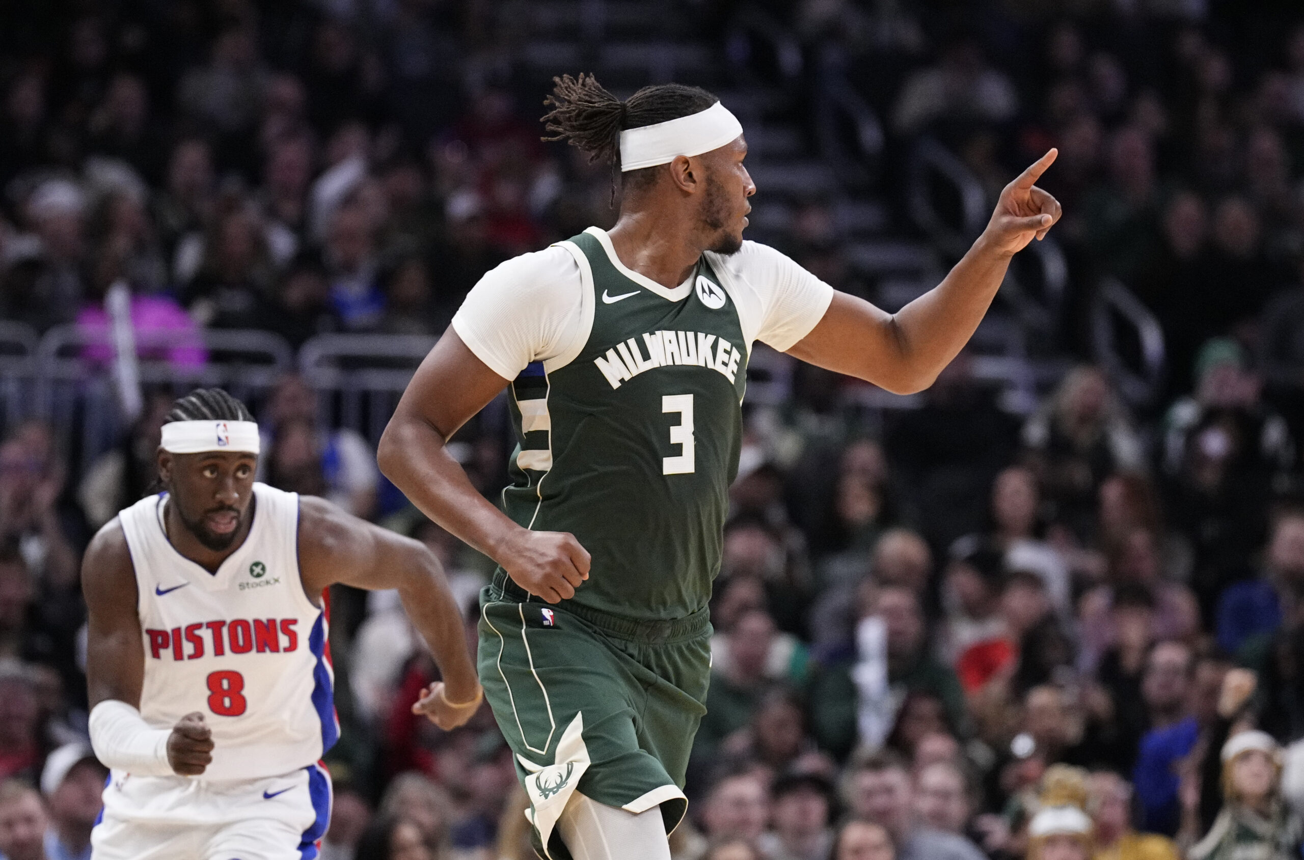 Nov 22, 2025; Milwaukee, Wisconsin, USA; Milwaukee Bucks center/forward Myles Turner (3) celebrates making a basket against Detroit Pistons guard Caris Levert (8) in the second half at Fiserv Forum. Mandatory Credit: Michael McLoone-Imagn Images