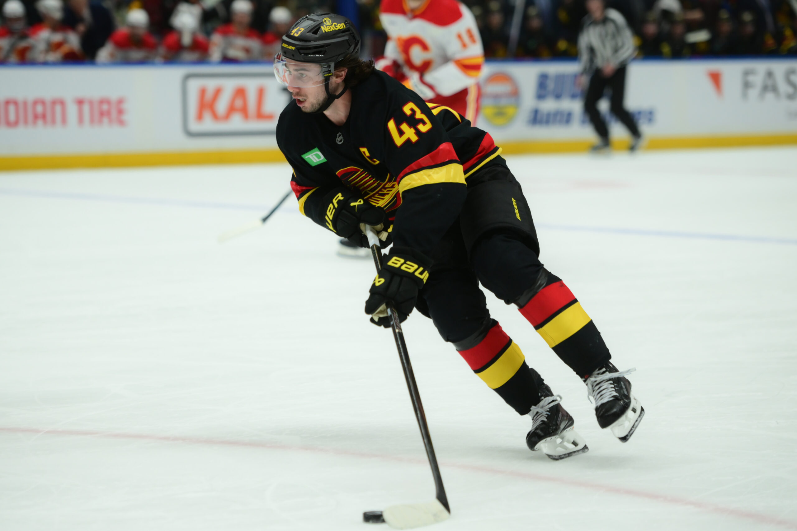 Nov 23, 2025; Vancouver, British Columbia, CAN;  Vancouver Canucks defenseman Quinn Hughes (43) skates with the puck during the third period against the Calgary Flames at Rogers Arena. Mandatory Credit: Simon Fearn-Imagn Images