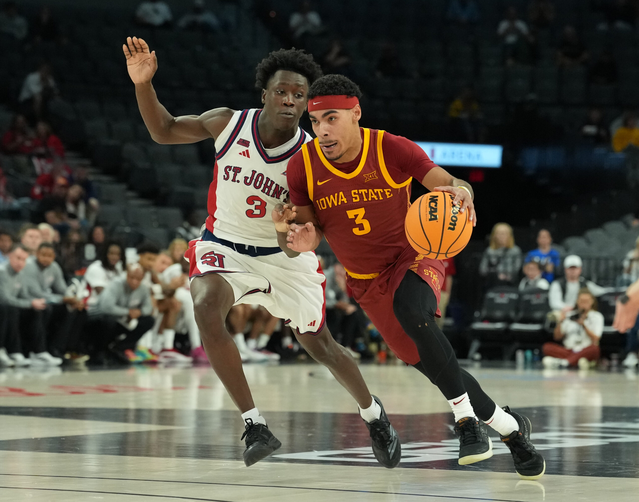 Nov 24, 2025; Las Vegas, Nevada, USA; Iowa State Cyclones guard Tamin Lipsey (3) drives to the hoop past St. John's Red Storm guard Joson Sanon (3) during the second half in a 2025 Players Era Festival group play game at Michelob Ultra Arena. Mandatory Credit: Kirby Lee-Imagn Images