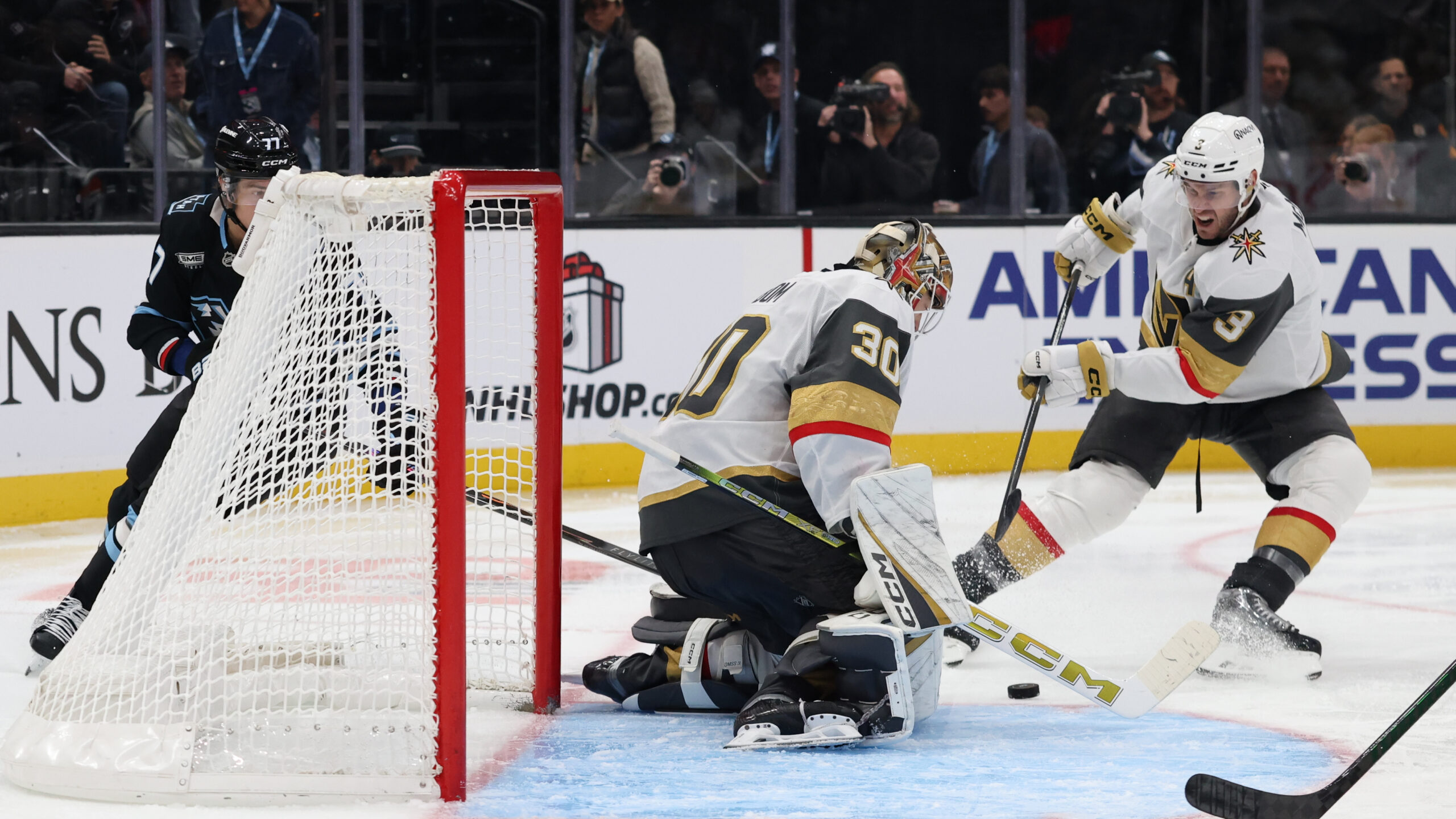 Nov 24, 2025; Salt Lake City, Utah, USA; Vegas Golden Knights goaltender Carl Lindbom (30) makes a save on a shot by Utah Mammoth right wing JJ Peterka (77) during the third period at Delta Center. Mandatory Credit: Rob Gray-Imagn Images
