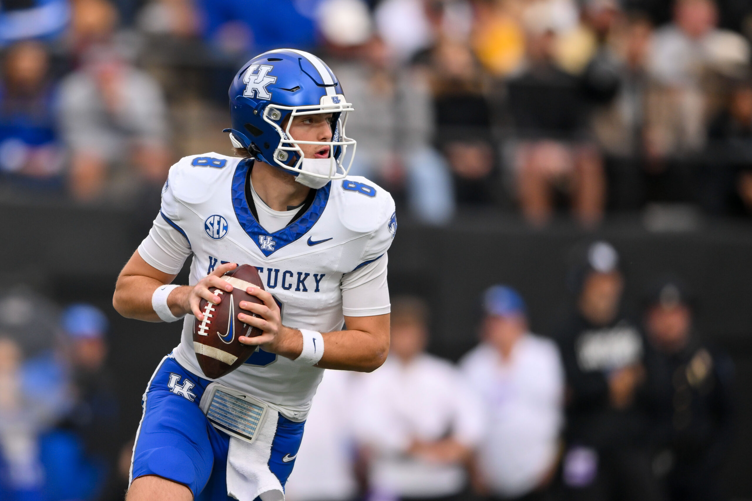 Nov 22, 2025; Nashville, Tennessee, USA; Kentucky Wildcats quarterback Cutter Boley (8) scrambles against the Vanderbilt Commodores during the first half at FirstBank Stadium. Mandatory Credit: Steve Roberts-Imagn Images