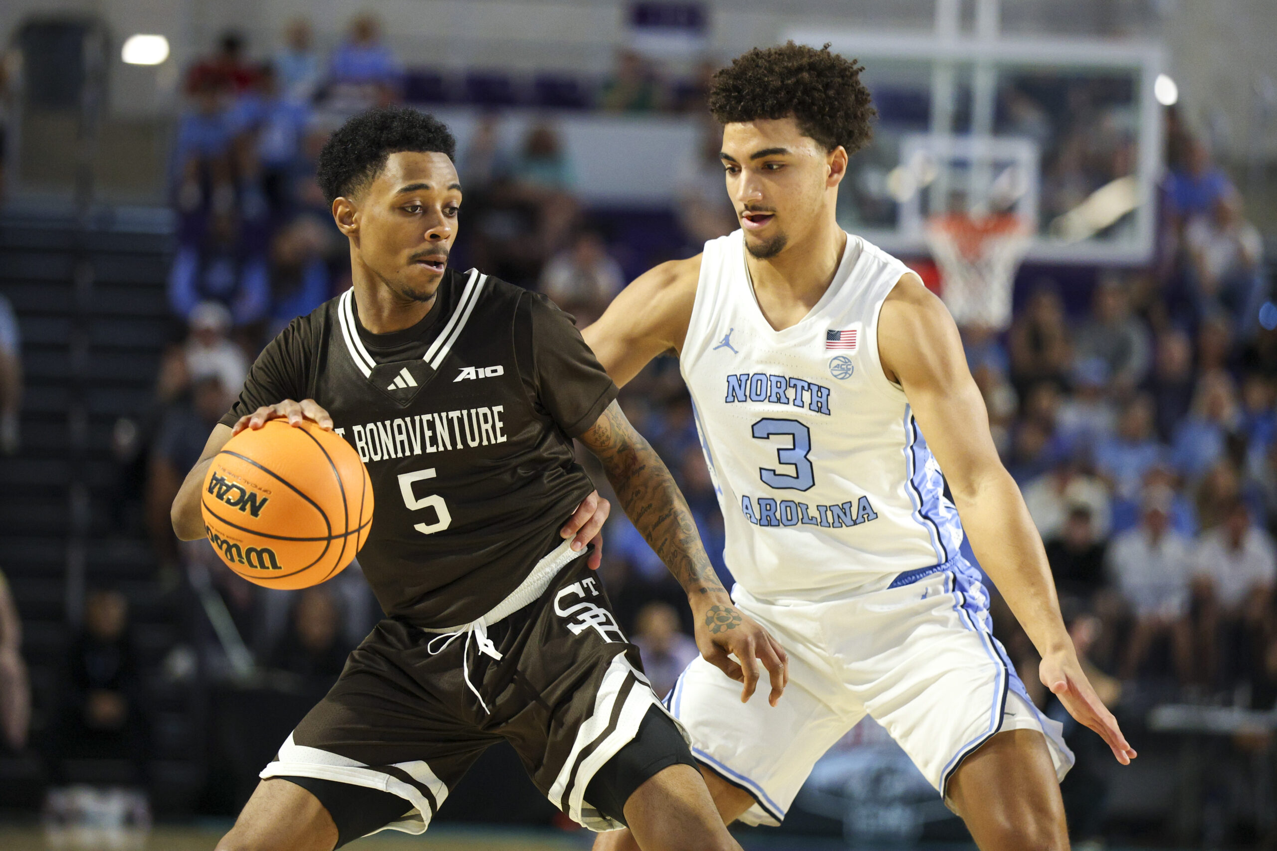 Nov 25, 2025; Fort Myers, Florida, USA; St. Bonaventure Bonnies guard Dasonte Bowen (5) is guarded by North Carolina Tar Heels guard Derek Dixon (3) in the second half at Suncoast Credit Union Arena. Mandatory Credit: Nathan Ray Seebeck-Imagn Images