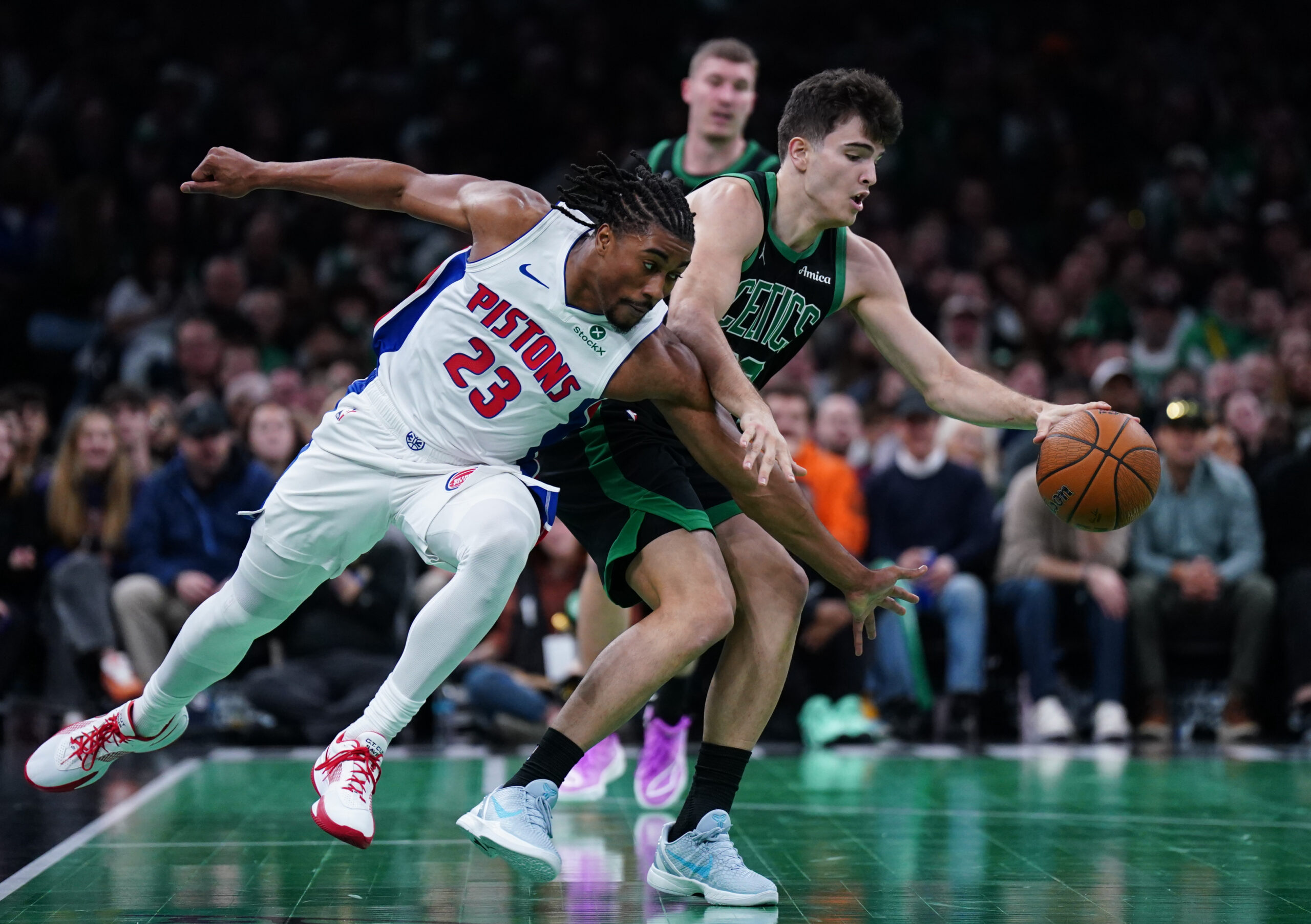 Nov 26, 2025; Boston, Massachusetts, USA; Detroit Pistons guard Jaden Ivey (23) defends against Boston Celtics guard Hugo Gonzalez (28) in the second half at TD Garden. Mandatory Credit: David Butler II-Imagn Images