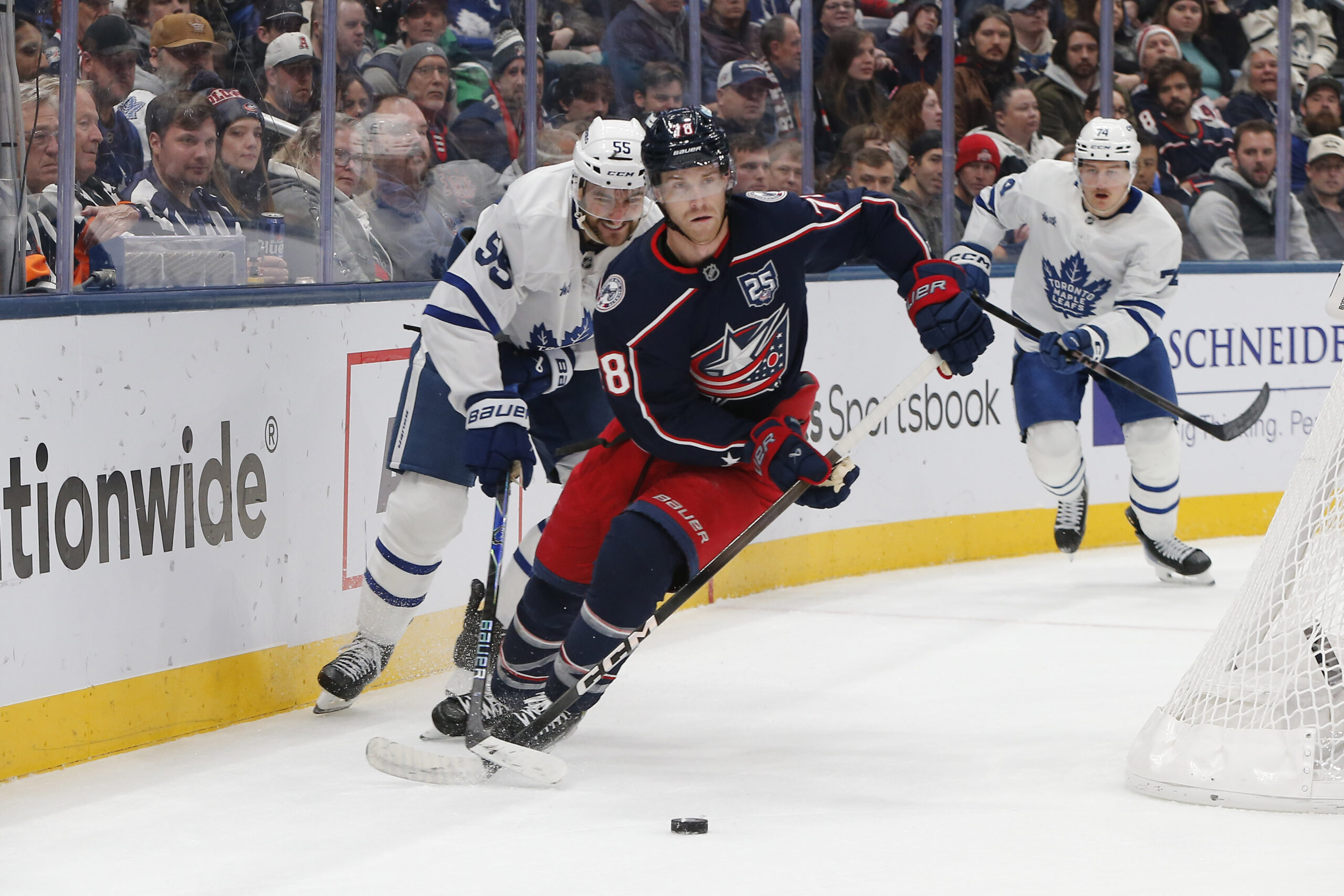 Nov 26, 2025; Columbus, Ohio, USA; Columbus Blue Jackets defenseman Zach Werenski (8) carries the puck as Toronto Maple Leafs center Nicolas Roy (55) trails the play during the first period at Nationwide Arena. Mandatory Credit: Russell LaBounty-Imagn Images