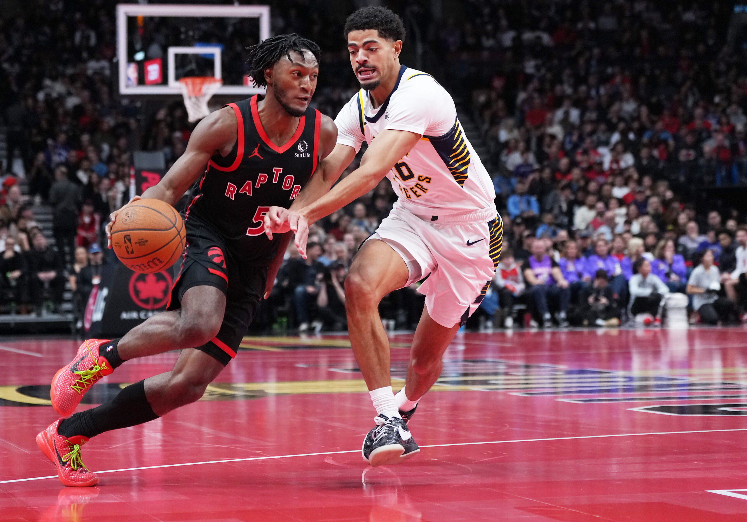 Nov 26, 2025; Toronto, Ontario, CAN; Toronto Raptors guard Immanuel Quickley (5) controls the ball as Indiana Pacers guard Ben Sheppard (26) tries to defend during the third quarter at Scotiabank Arena. Mandatory Credit: Nick Turchiaro-Imagn Images