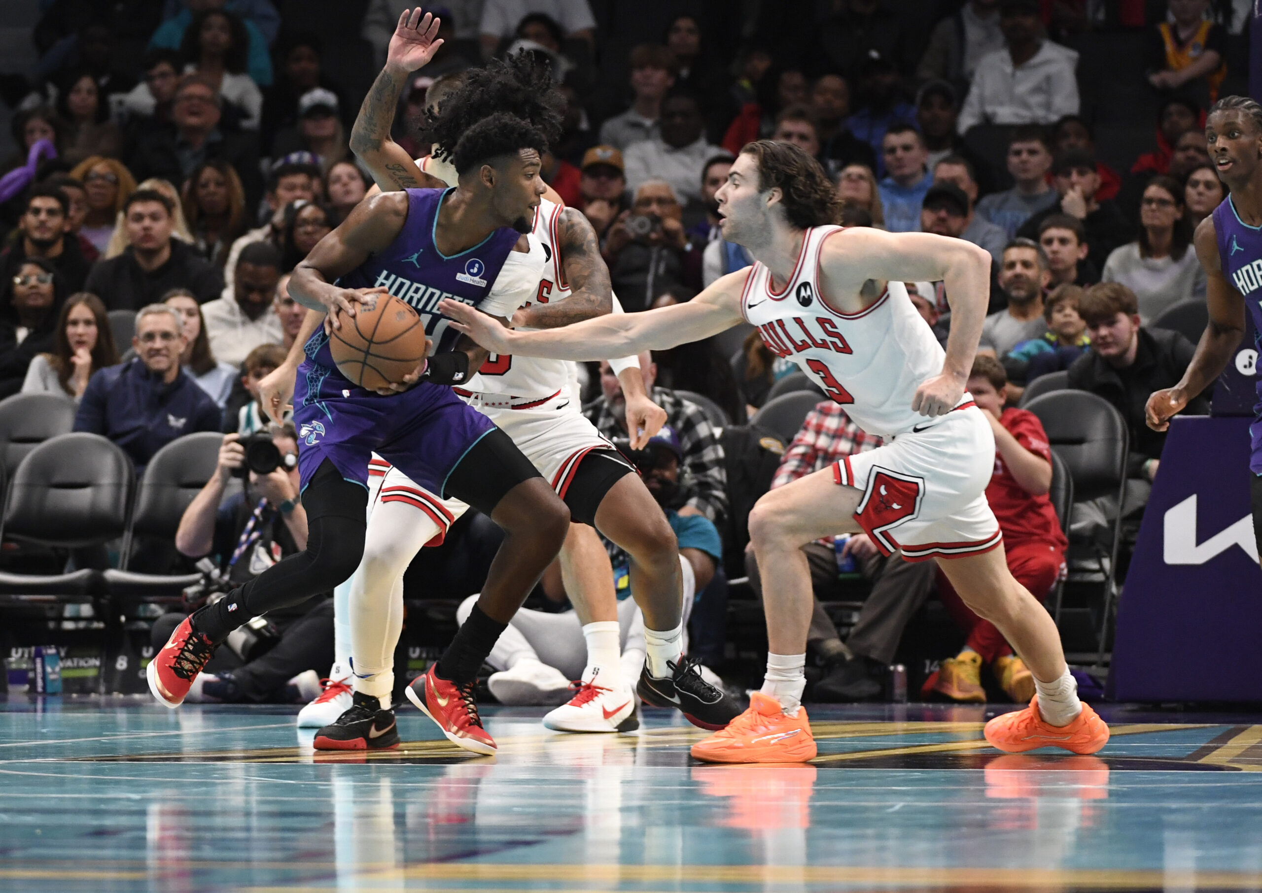 Nov 28, 2025; Charlotte, North Carolina, USA; Charlotte Hornets forward Brandon Miller (24) looks to drive in as he is defended by Chicago Bulls guard Josh Giddey (3) during the second half at the Spectrum Center. Mandatory Credit: Sam Sharpe-Imagn Images