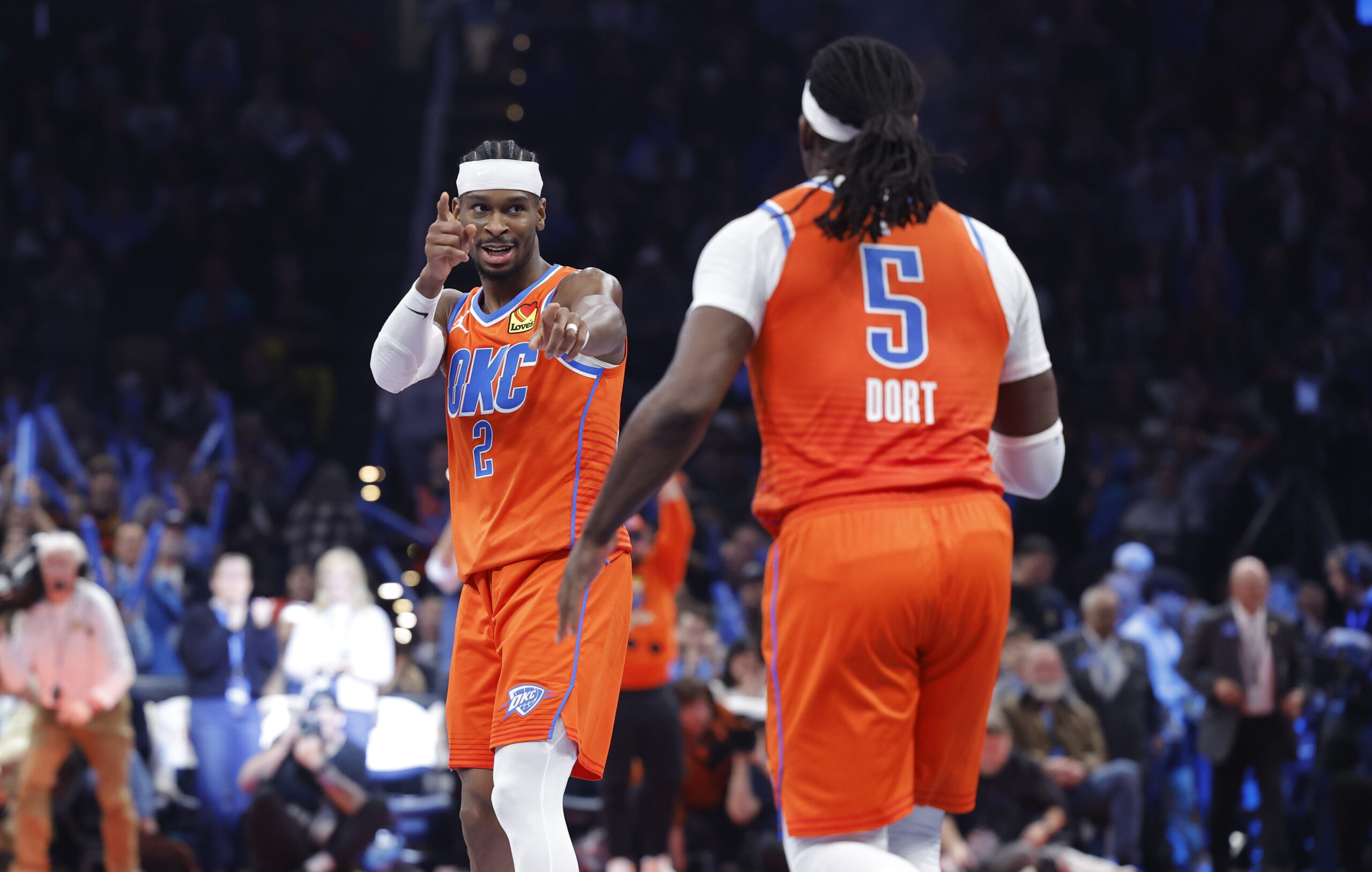 Nov 28, 2025; Oklahoma City, Oklahoma, USA; Oklahoma City Thunder guard Shai Gilgeous-Alexander (2) gestures towards guard Luguentz Dort (5) after a basket against the Phoenix Suns during the second half at Paycom Center. Mandatory Credit: Alonzo Adams-Imagn Images
