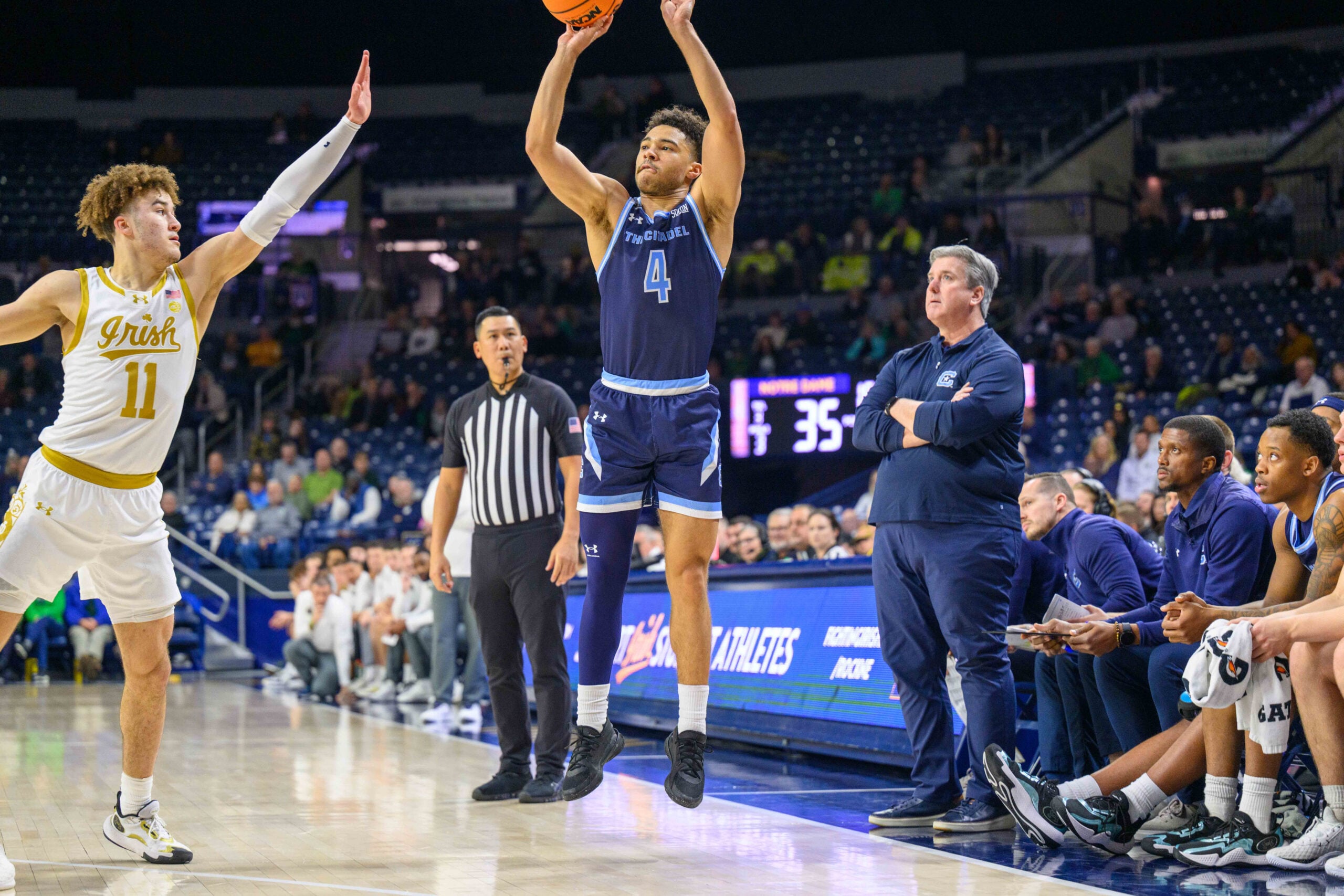 Dec 19, 2023; South Bend, Indiana, USA; Citadel Bulldogs guard Elijah Morgan (4) shoots a three point basket over Notre Dame Fighting Irish guard Braeden Shrewsberry (11) in the second half at the Purcell Pavilion. Mandatory Credit: Matt Cashore-Imagn Images