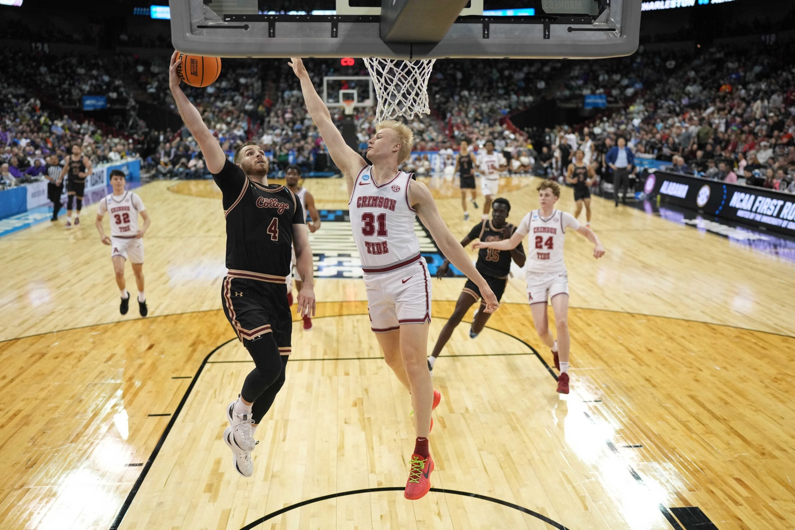 Mar 22, 2024; Spokane, WA, USA; Charleston Cougars guard Bryce Butler (4) shoots the ball against Alabama Crimson Tide forward Max Scharnowski (31) during the second half in the first round of the 2024 NCAA Tournament against Charleston Cougars at Spokane Veterans Memorial Arena. Mandatory Credit: Kirby Lee-Imagn Images