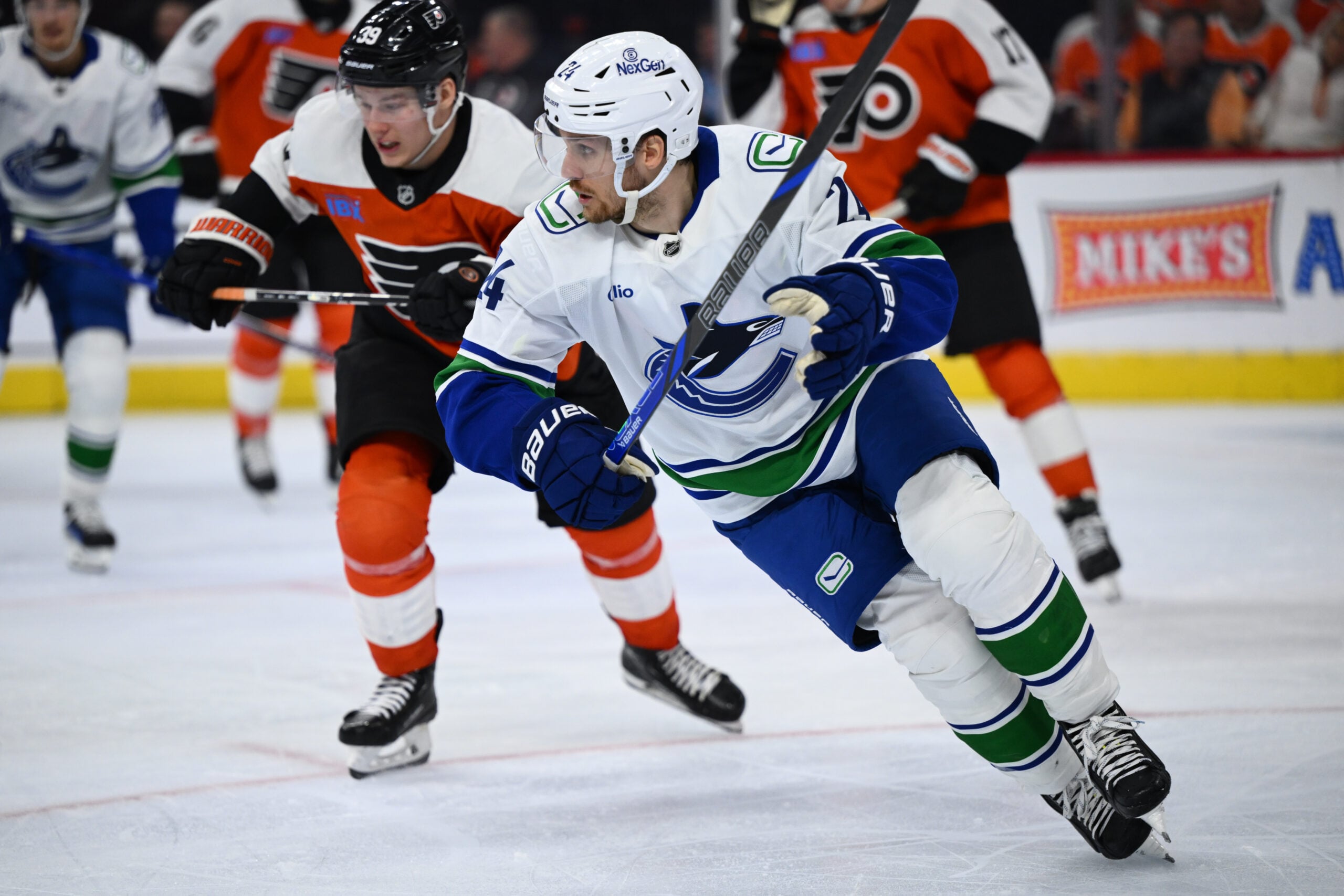 Oct 19, 2024; Philadelphia, Pennsylvania, USA; Vancouver Canucks center Pius Suter (24) skates against Philadelphia Flyers right wing Matvei Michkov (39) in the third period at Wells Fargo Center. Mandatory Credit: Kyle Ross-Imagn Images