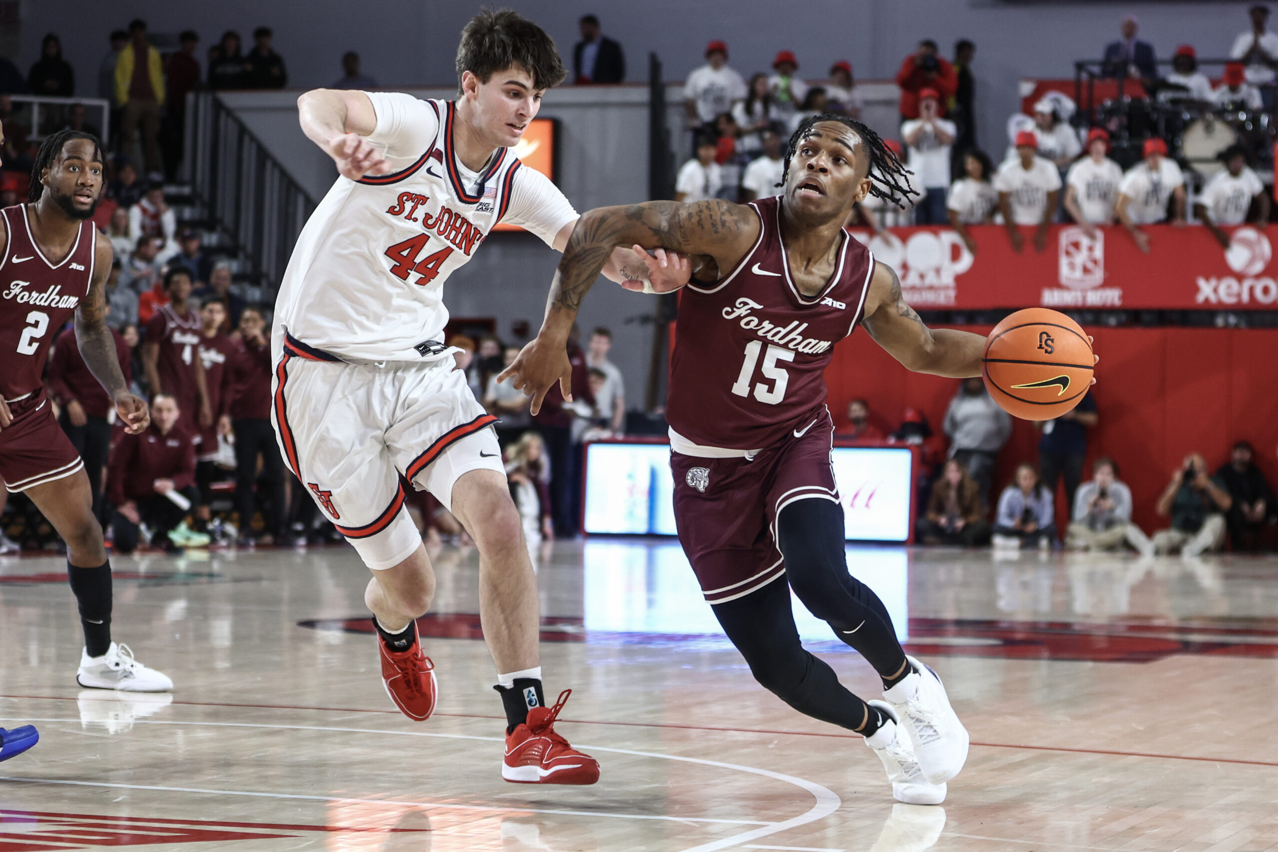 Nov 4, 2024; Queens, New York, USA; Fordham Rams guard Jackie Johnson III (15) looks to drive past St. John's Red Storm forward Brady Dunlap (44) in the first half at Carnesecca Arena. Mandatory Credit: Wendell Cruz-Imagn Images