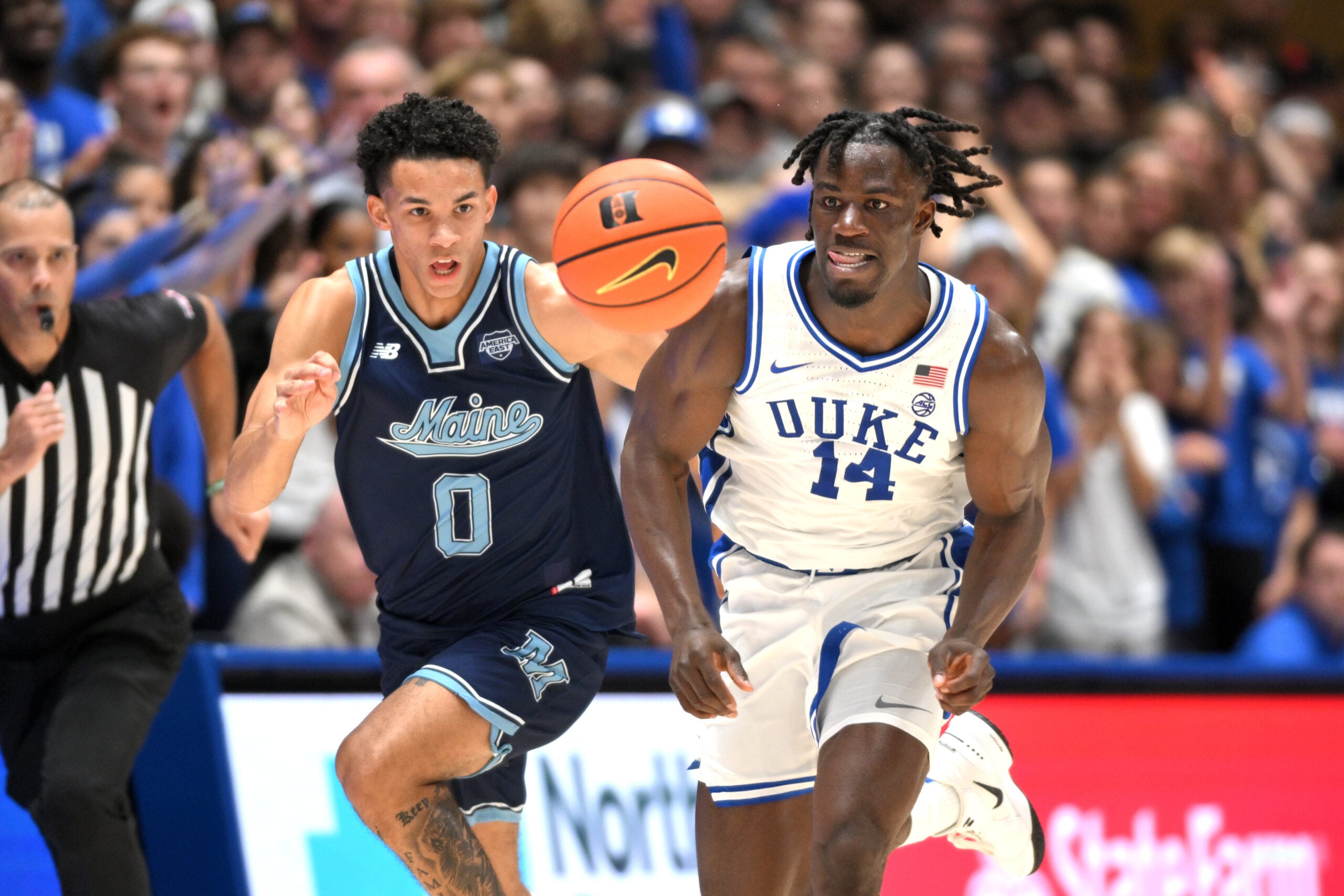 Nov 4, 2024; Durham, North Carolina, USA; Duke Blue Devils guard Sion James (14) brings the ball down the court under defensive pressure from Maine Black Bears guard Logan Carey (0) in the second half at Cameron Indoor Stadium. Mandatory Credit: Zachary Taft-Imagn Images