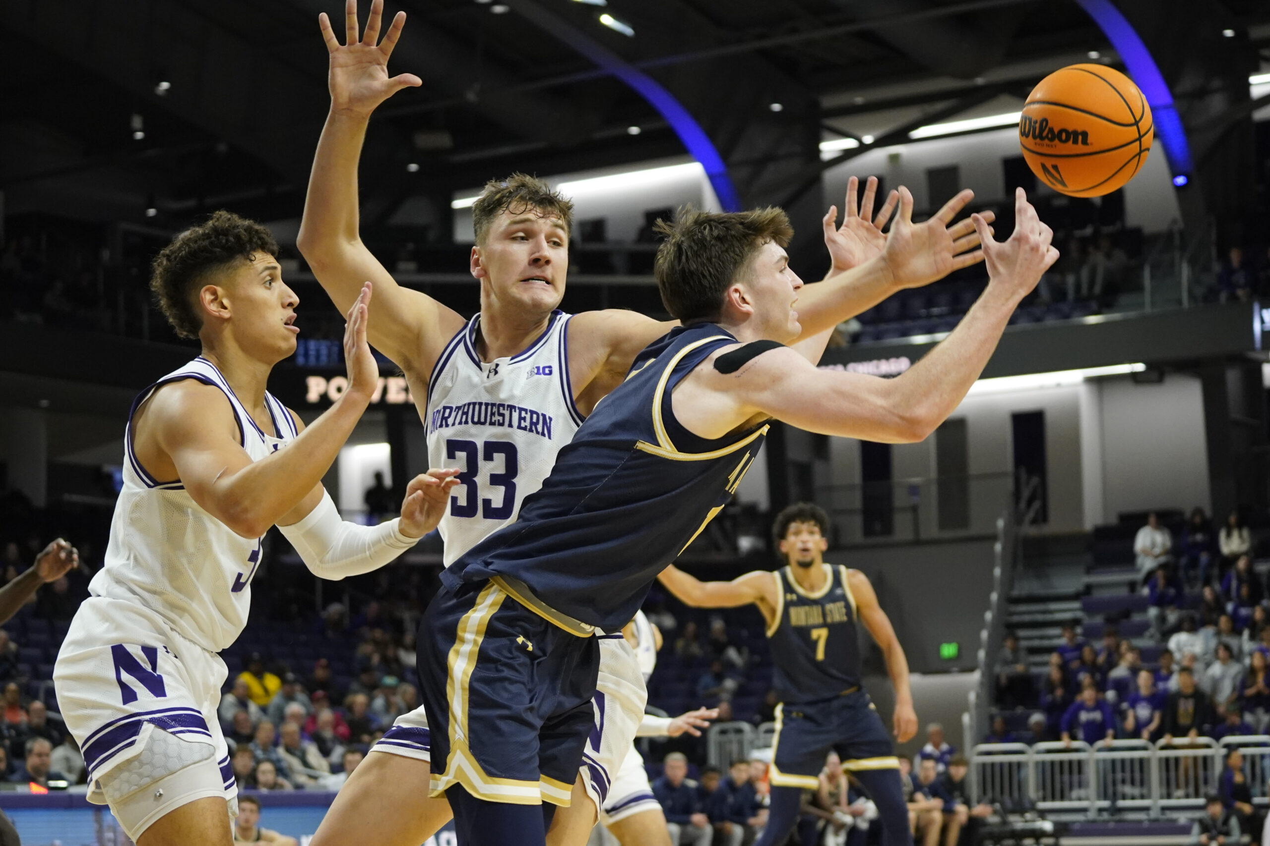 Nov 19, 2024; Evanston, Illinois, USA; Montana State Bobcats guard Patrick McMahon (1) and Northwestern Wildcats forward Luke Hunger (33) go for the ball during the first half at Welsh-Ryan Arena. Mandatory Credit: David Banks-Imagn Images