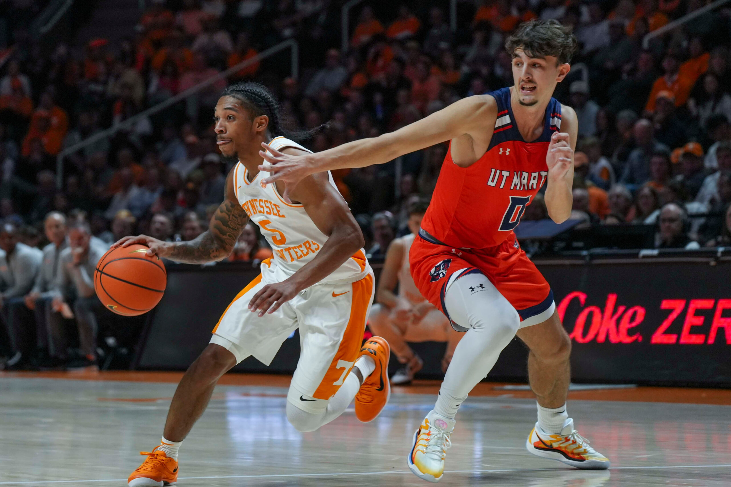 Tennessee guard Zakai Zeigler (5) runs around UT Martin's Andrija Bukumirovic (0) during an NCAA basketball game between the Tennessee Volunteers and UT Martin Skyhawks at Thompson-Boling Arena at Food City Center on Wednesday, Nov. 27, 2024. Mandatory Credit: Angelina Alcantar/USA TODAY NETWORK via Imagn Images
